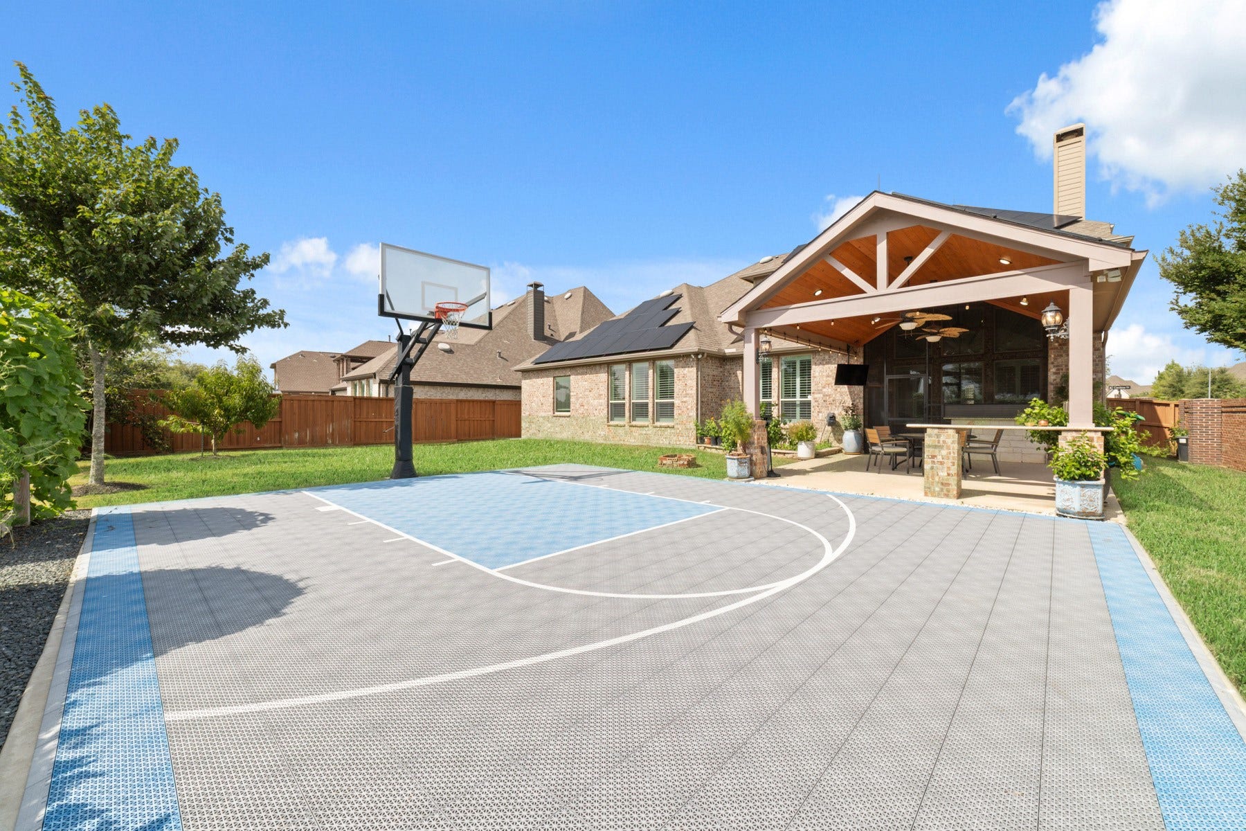 Stunning backyard with a private basketball court, perfect for outdoor entertainment and recreation.
