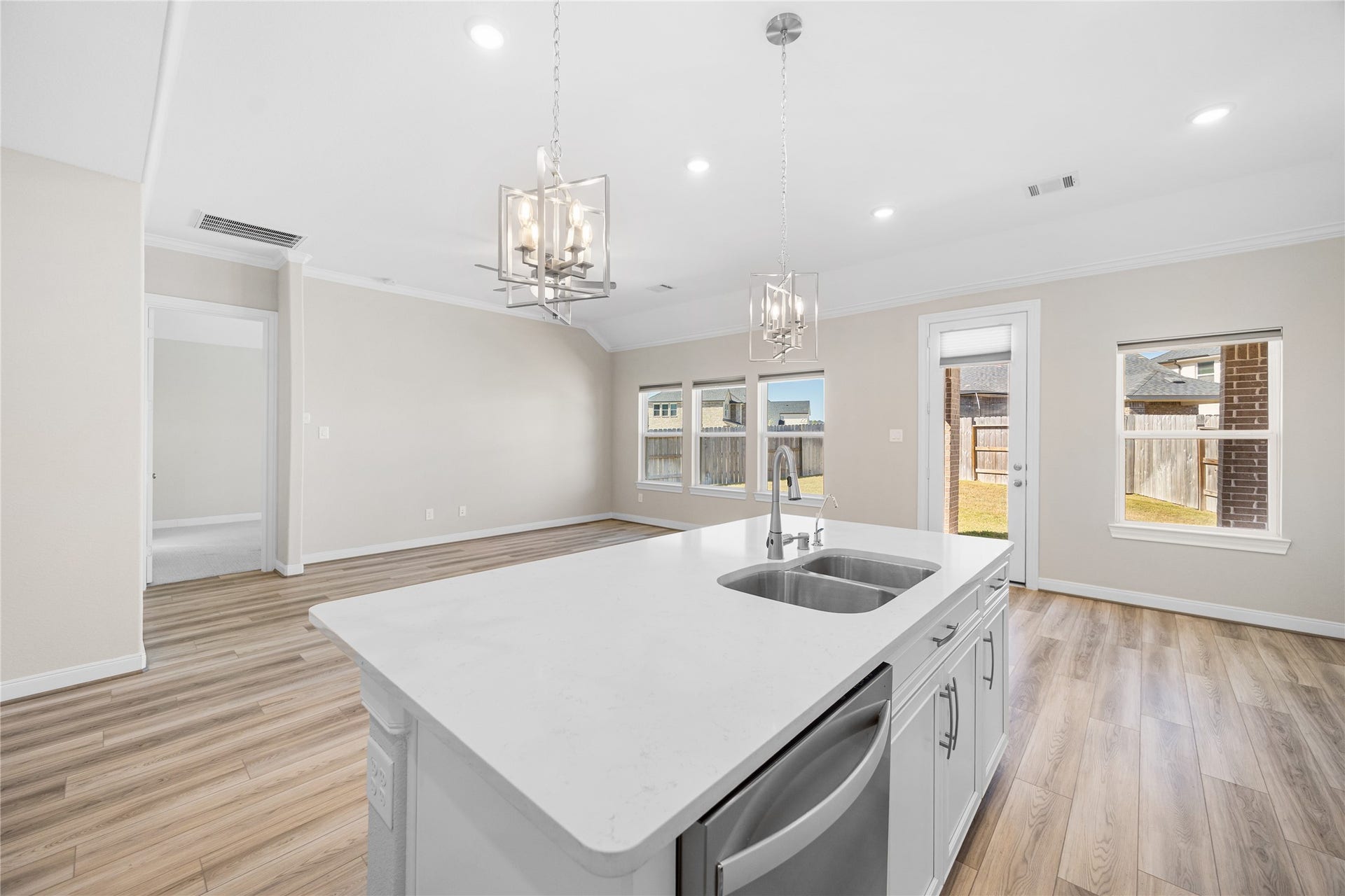 17681 Rosette Grass Drive, Conroe, TX 77385 The open layout provides a seamless flow from the kitchen to living room