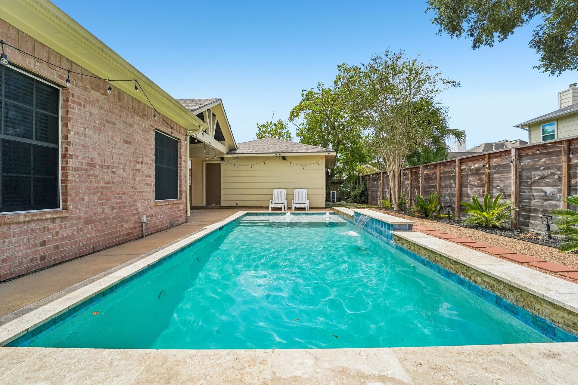 Enjoy a refreshing oasis with this inviting backyard pool, perfect for relaxation and outdoor entertaining.
