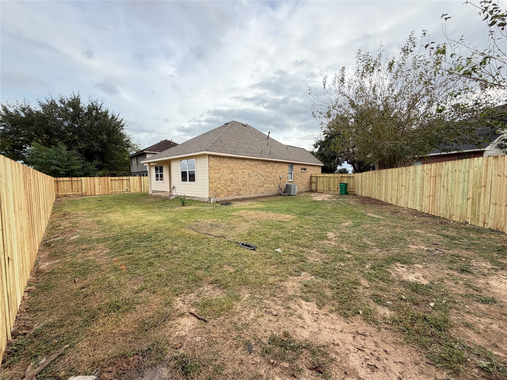 Charming backyard with a spacious lawn, privacy fence, and a cozy covered patio perfect for relaxing or entertaining. No back neighbors.
