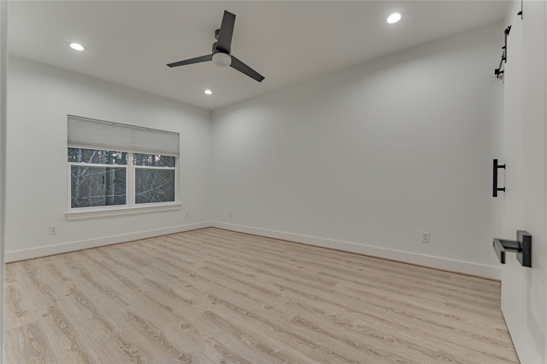 Additionally, the second floor offers two spacious bedrooms, each with a private ensuite bath. Both rooms enjoy tranquil views of the surrounding trees. This is secondary bedroom #1.