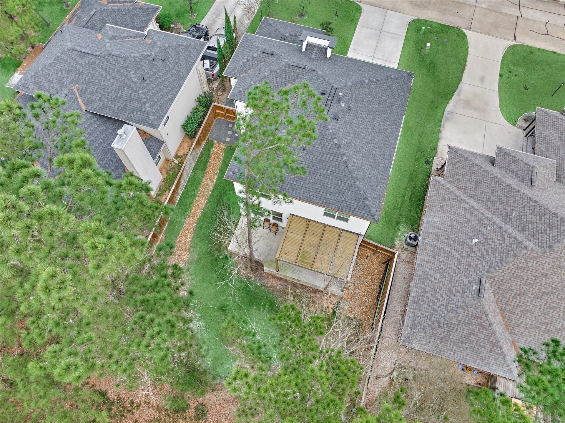 This beautiful, spacious backyard, framed by majestic trees, offers a serene and peaceful setting.