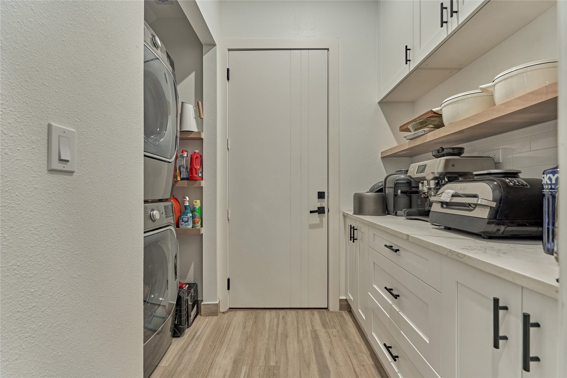 Laundry room with adjacent butlers pantry off the kitchen offers generous storage.