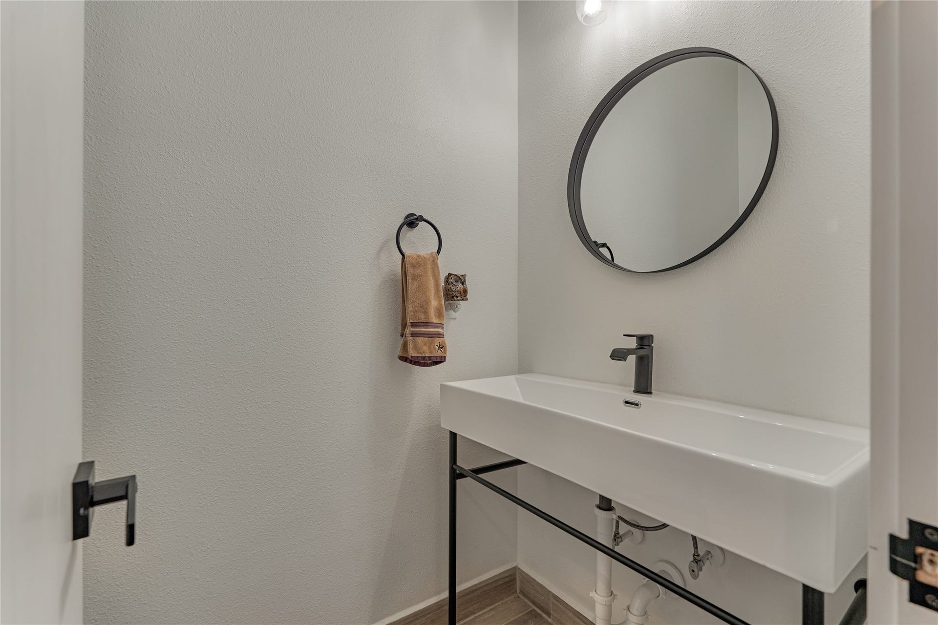 Tucked toward the entry, a well-appointed half bath offers easy access for guests and everyday use