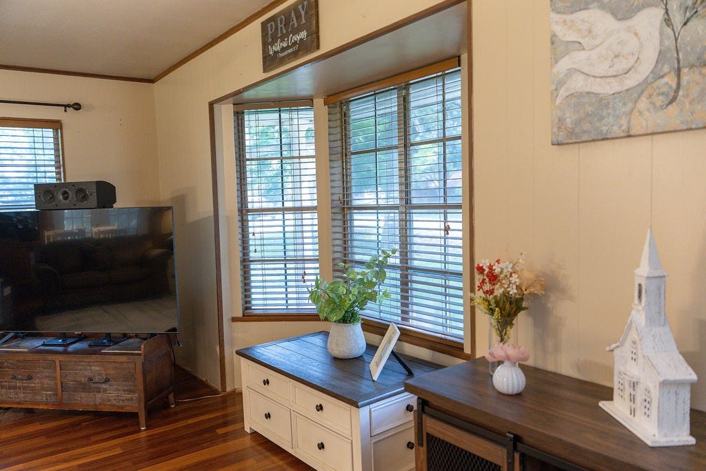 1314 Laurel Street, La Marque, TX 77568 A classic bay window overlooks the stunning mature trees in the front yard, filling the room with natural light while providing a peaceful view and adding timeless charm to the space