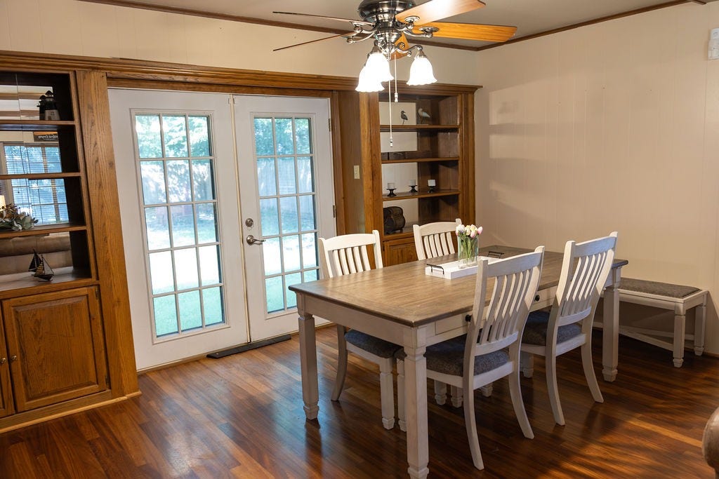 1314 Laurel Street, La Marque, TX 77568 The elegant dining room is enhanced by custom built-ins that add both style and functionality, creating a warm, sophisticated space that's perfect for everyday meals, holiday dinners, and special occasions.