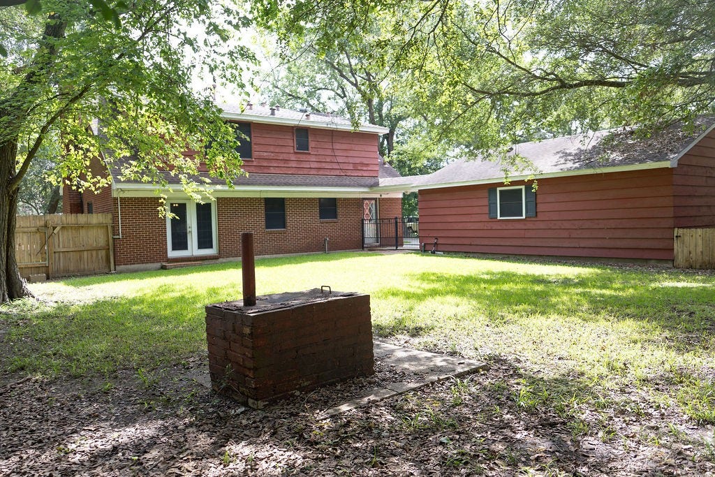 1314 Laurel Street, La Marque, TX 77568 Take a look at this spacious, fenced backyard! With plenty of room to relax, play, or entertain, it's a space the whole family can enjoy. The custom brick smoker is the perfect finishing touch, ready for backyard barbecues, holiday cookouts, and making memories with family and friends.