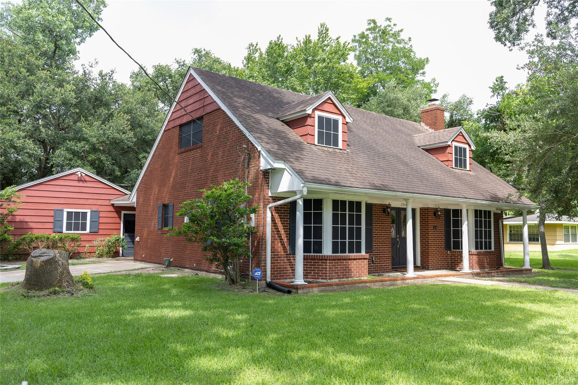 1314 Laurel Street, La Marque, TX 77568 1314 Laurel features a spacious front porch, mature trees, and a well-maintained lawn, offering a welcoming and serene atmosphere.