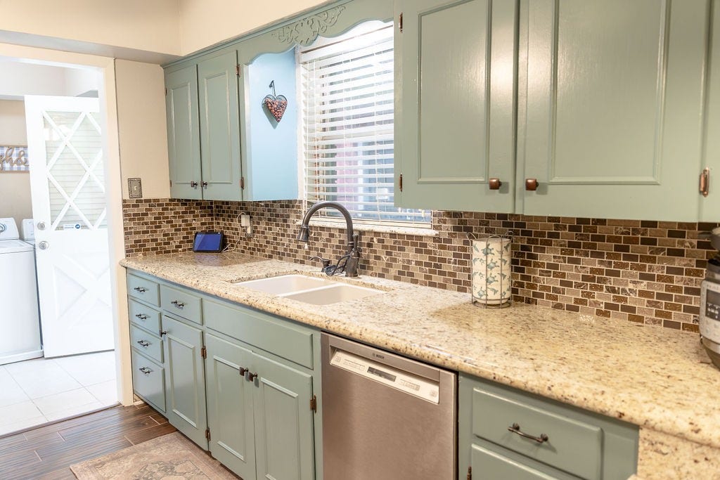 1314 Laurel Street, La Marque, TX 77568 Beautiful custom-built cabinetry, painted in a rich, modern blue, creates a stunning focal point in the kitchen. Paired with elegant granite countertops, this space offers the perfect blend of timeless style, abundant storage, and everyday functionality.