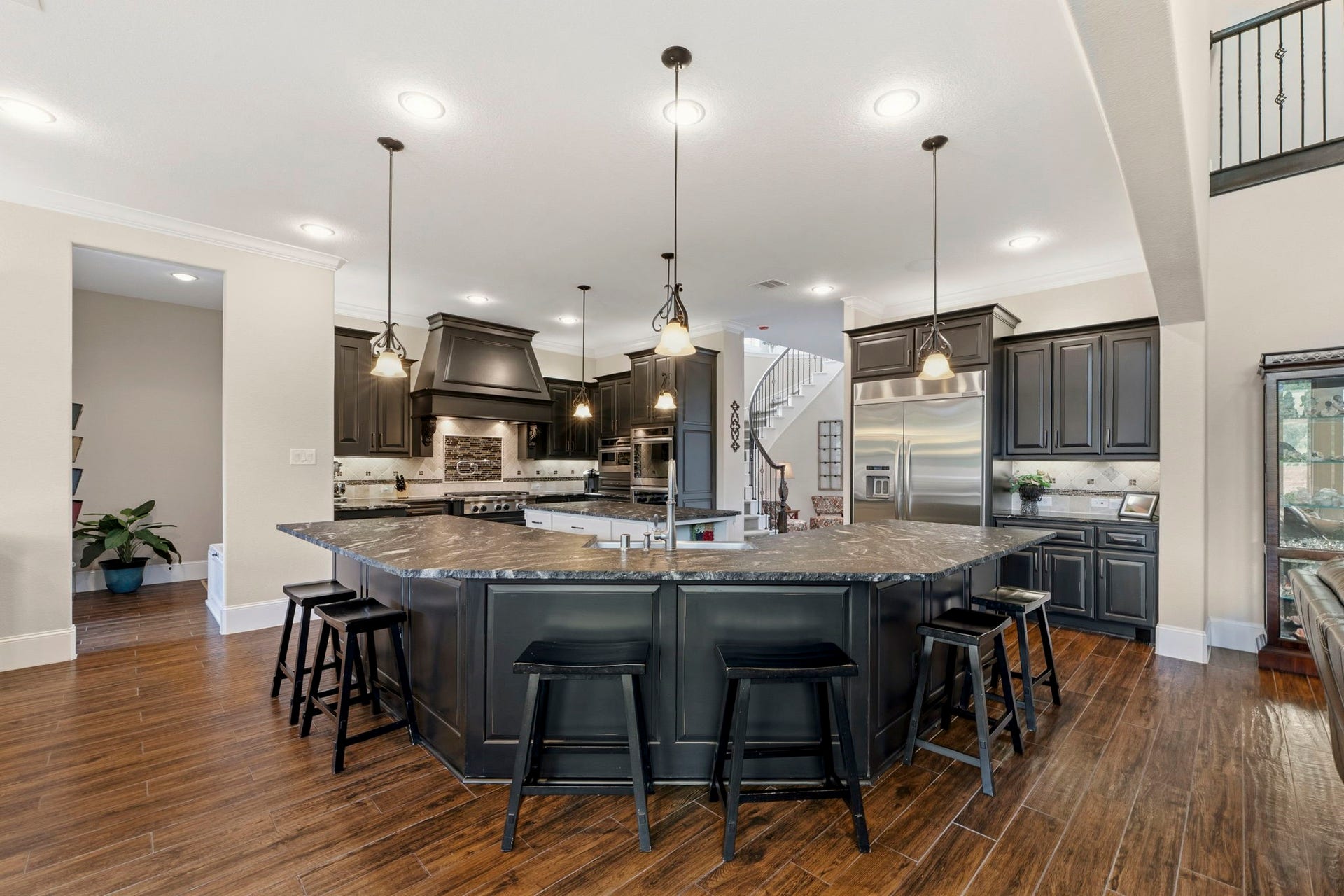 This floorplan was customized and extended to offer ample room in this Kitchen and Dining area. Luxurious leathered granite, upgraded appliances and beautiful custom cabinetry give this Kitchen the wow factor!