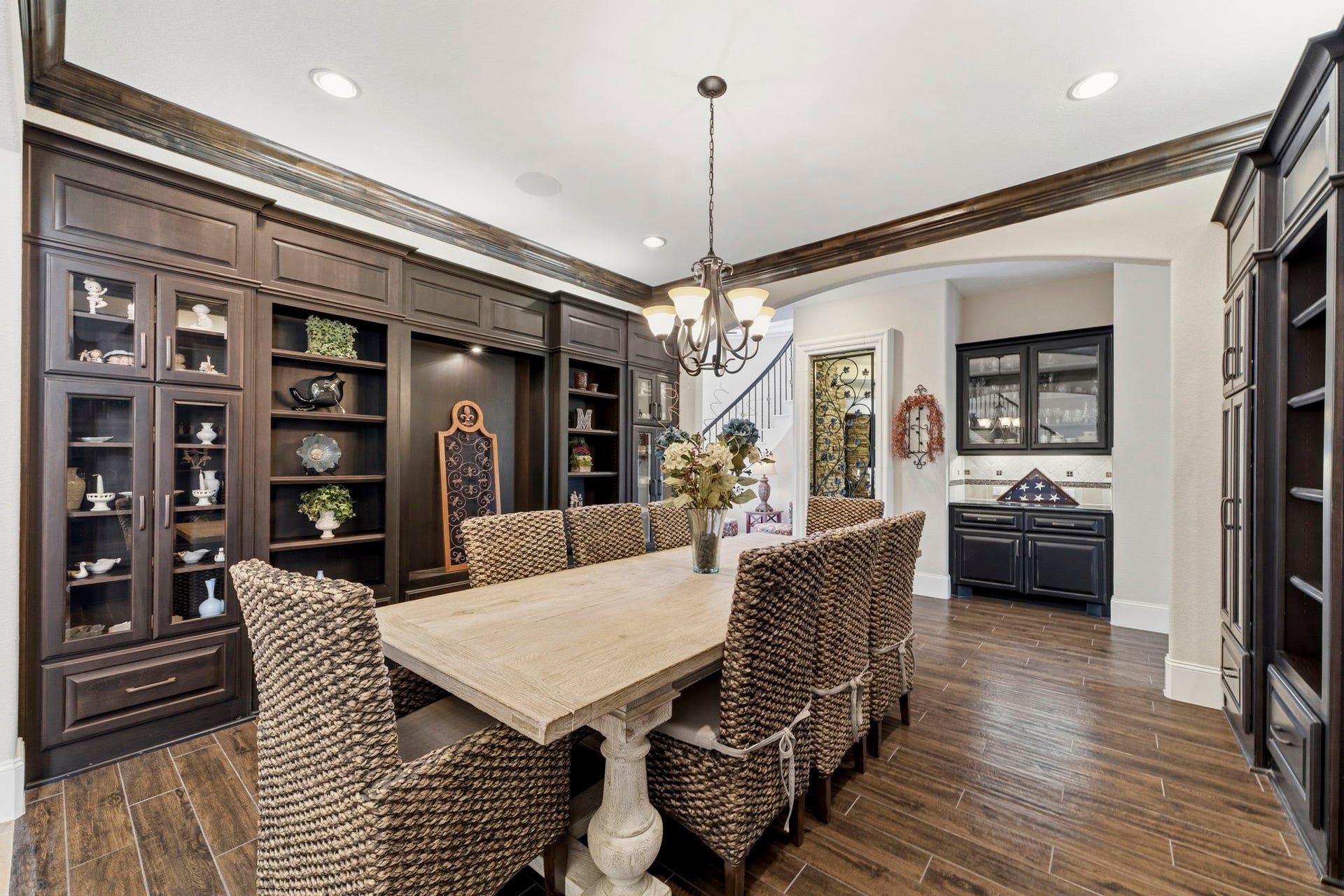 Very spacious Dining Room with custom built-ins, crown moulding and beautiful wood-like tile floors.