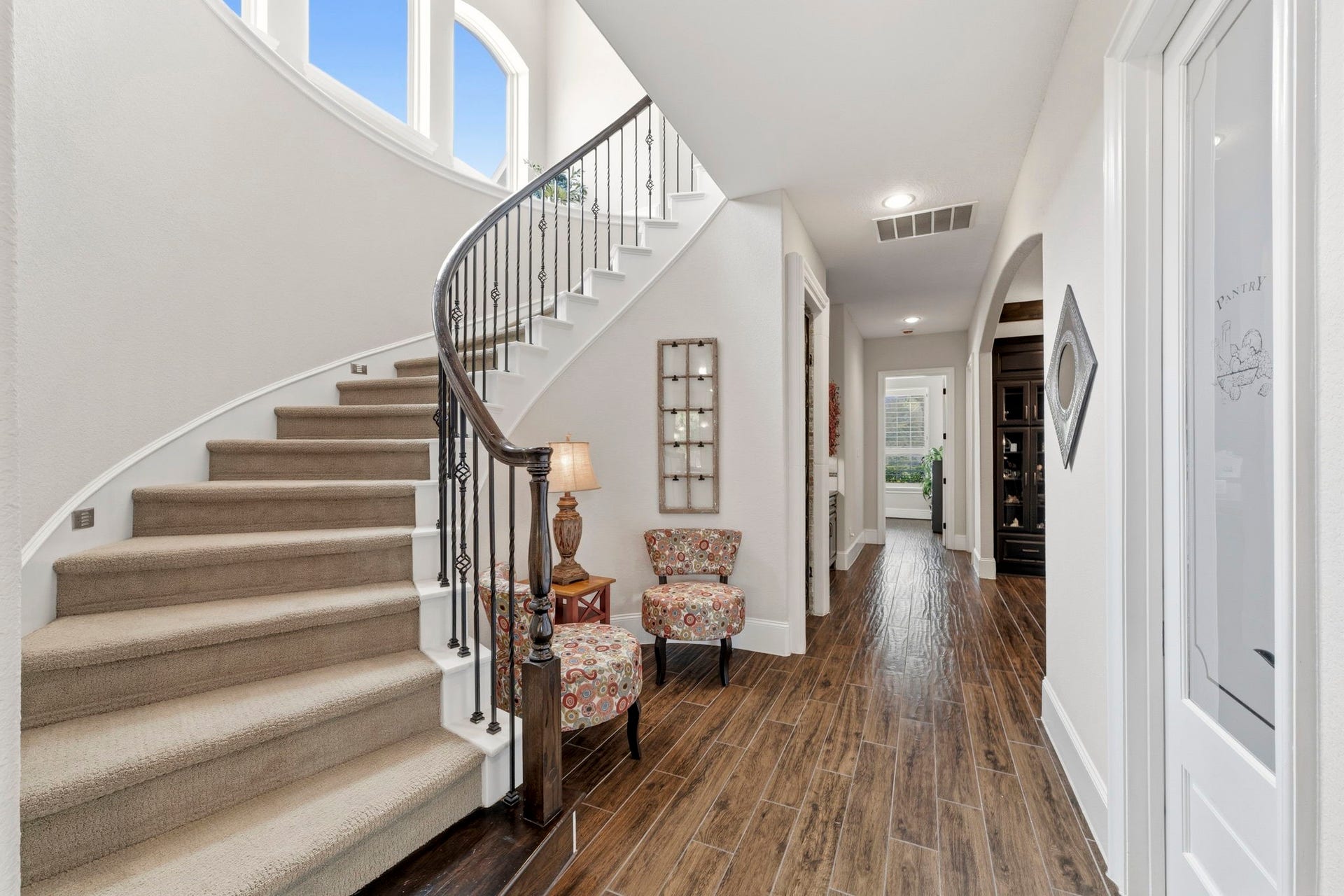 Second staircase behind the Dining Room shows the hallway to the Pantry, Wine Grotto and Secondary Bedroom downstairs