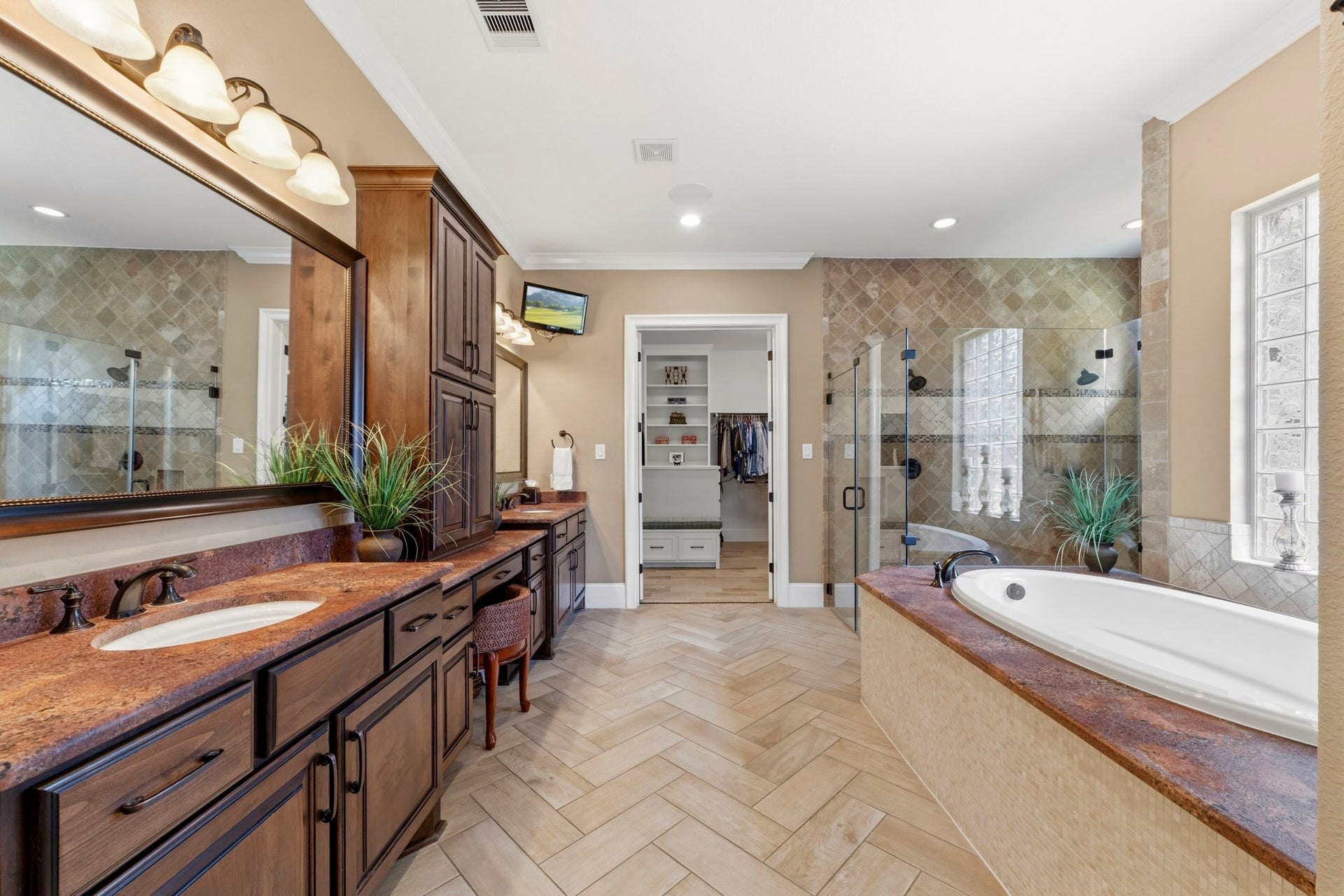 You will never want to leave this spacious Primary Bath with an oversized shower, soaking tub, and a unique upgraded granite that is sure to impress!