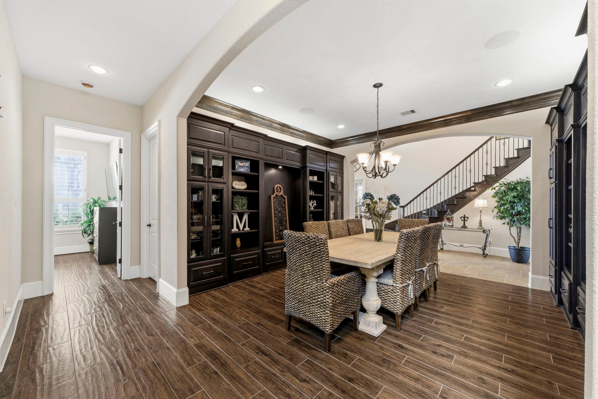 Very spacious Dining Room with custom built-ins, crown moulding and beautiful wood-like tile floors.