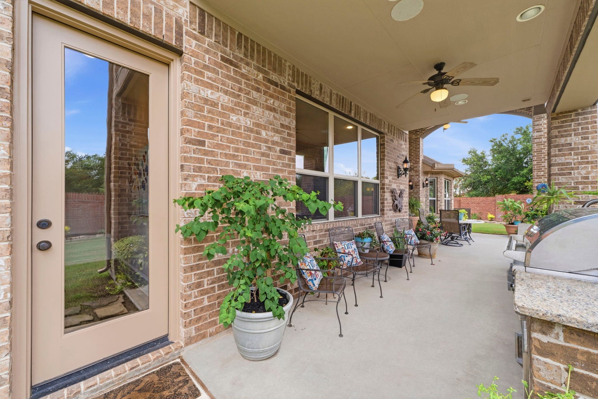 Beautiful Brick wall for added privacy and no back neighbors! Enjoy an extended covered patio and outdoor Kitchen.