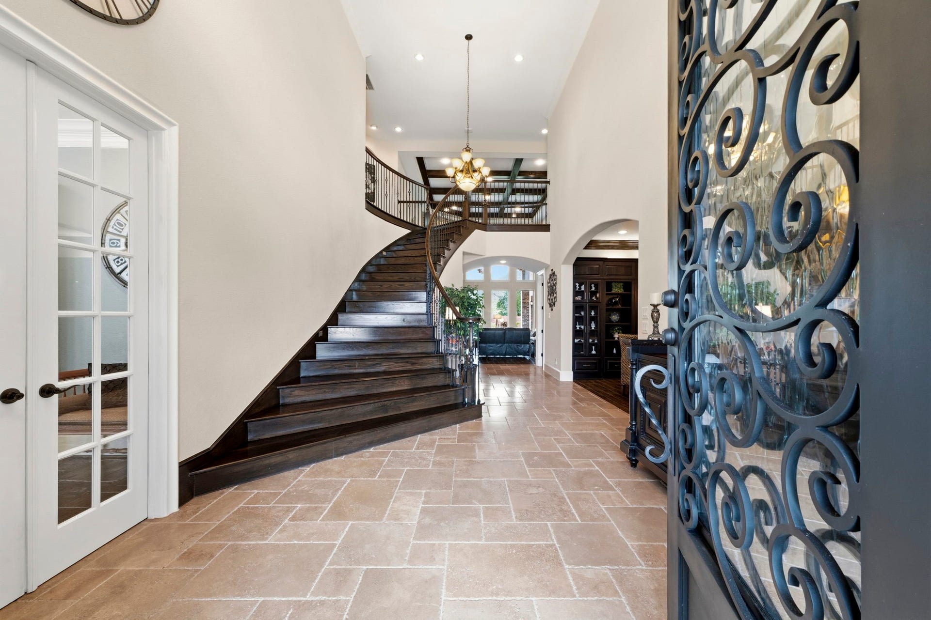Oversized decorative rod iron door opens into your grand entryway. Your Home Office is on your left and your Dining Room is inside and to the Right.