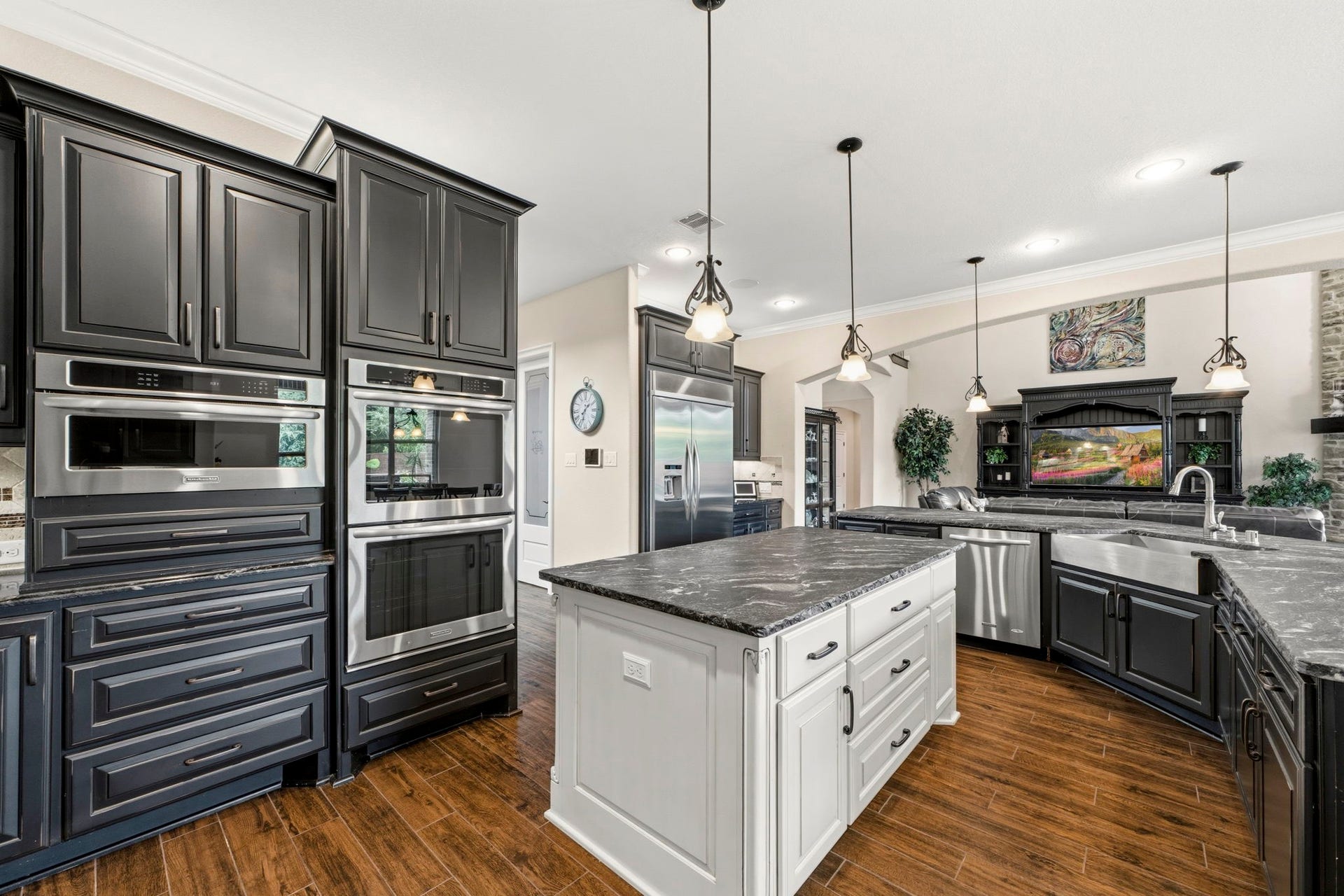 This floorplan was customized and extended to offer ample room in this Kitchen and Dining area. Luxurious leathered granite, upgraded appliances and beautiful custom cabinetry give this Kitchen the wow factor!
