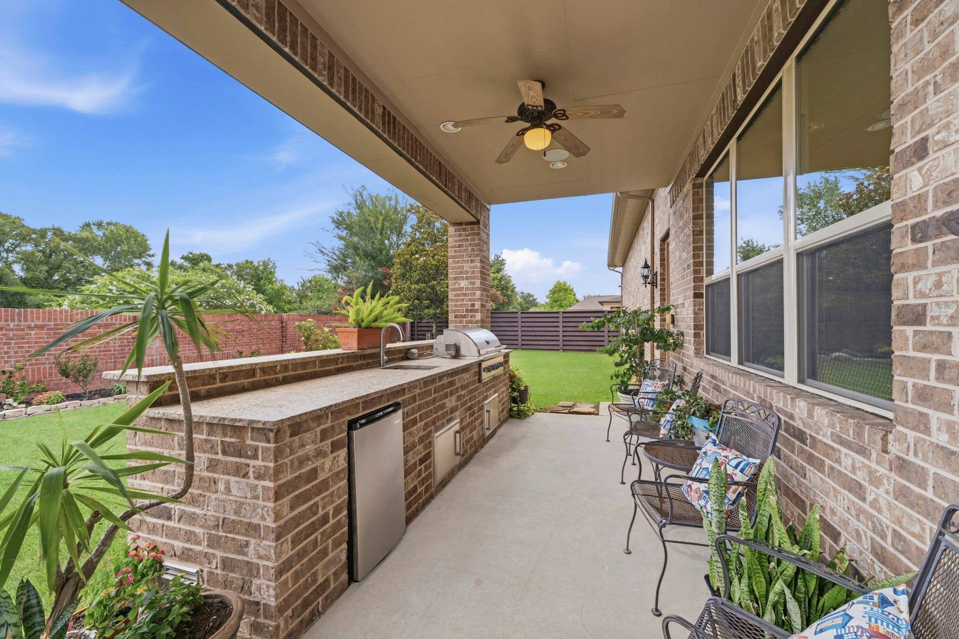 Beautiful Brick wall for added privacy and no back neighbors! Enjoy an extended covered patio and outdoor Kitchen.