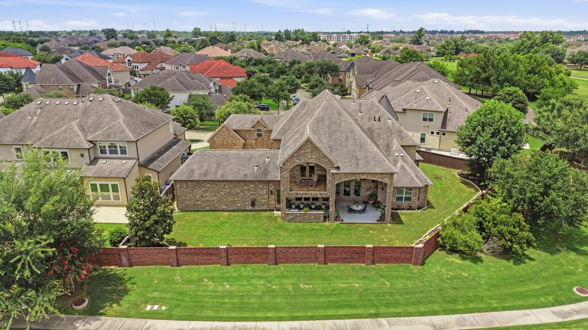 Plenty of room for a pool and no back neighbors! Gorgeous brick wall adds an extra luxurious touch to the backyard.