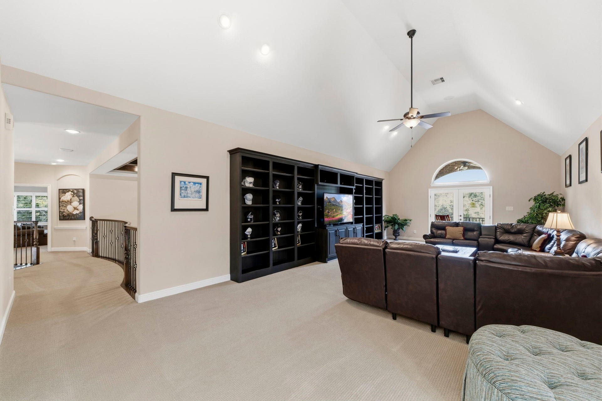Another area that was thoughtfully customized to extend the square footage was the upstairs Gameroom! Plenty of room for large families and/or large parties. Also beautiful custom shelves