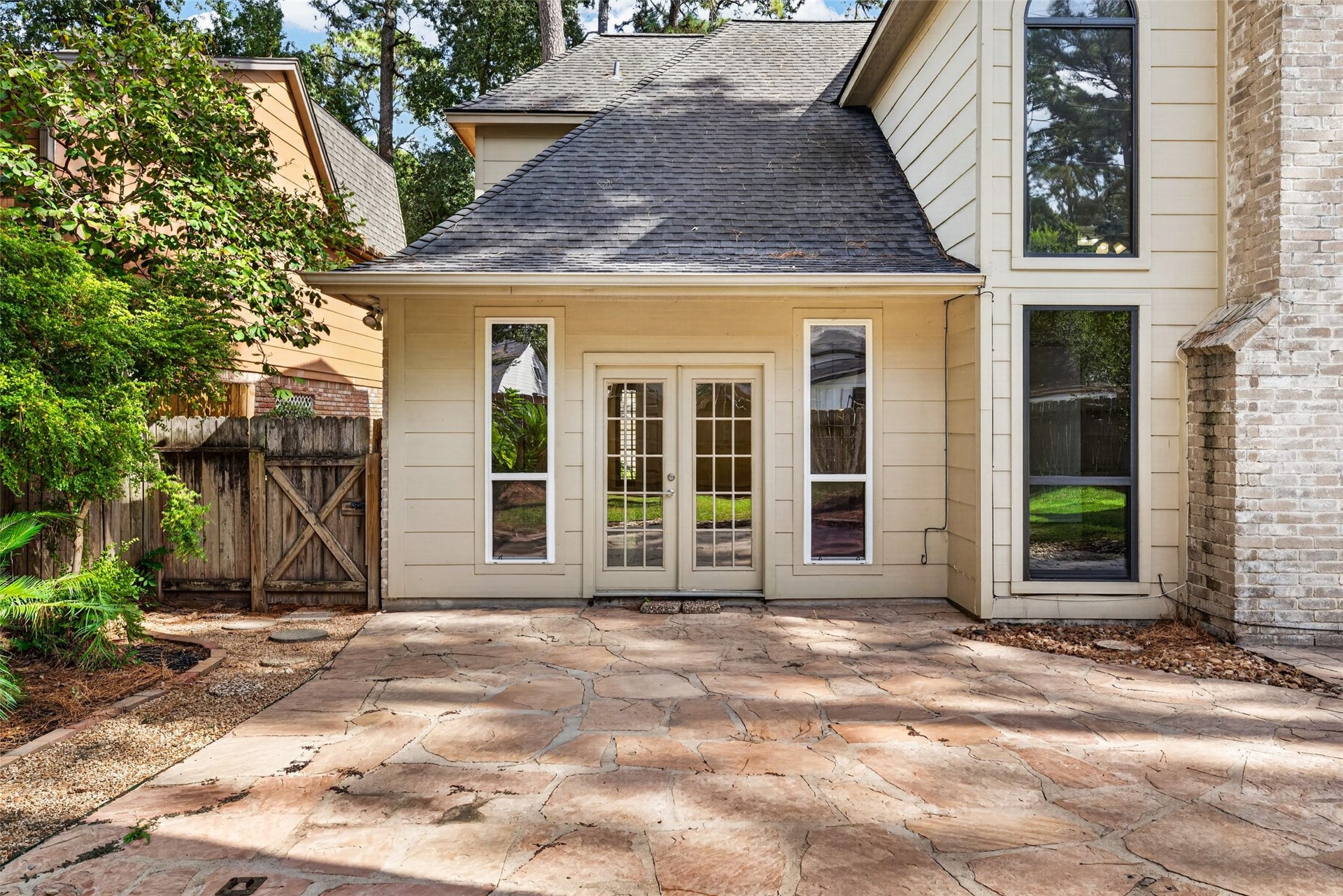6206 Willow Pine Drive, Spring, TX 77379 The primary suite is just beyond these french doors extedning the the primary suite to the back patio.