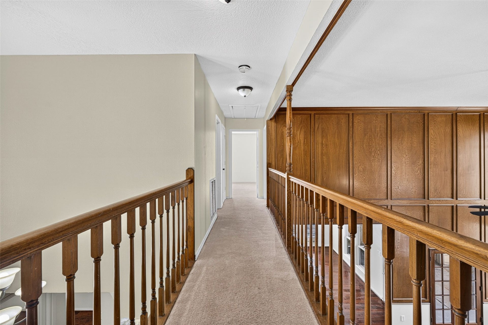 6206 Willow Pine Drive, Spring, TX 77379 The upper-level cat walk balcony connects the upstairs bedrooms while offering a view of the beautiful living room.