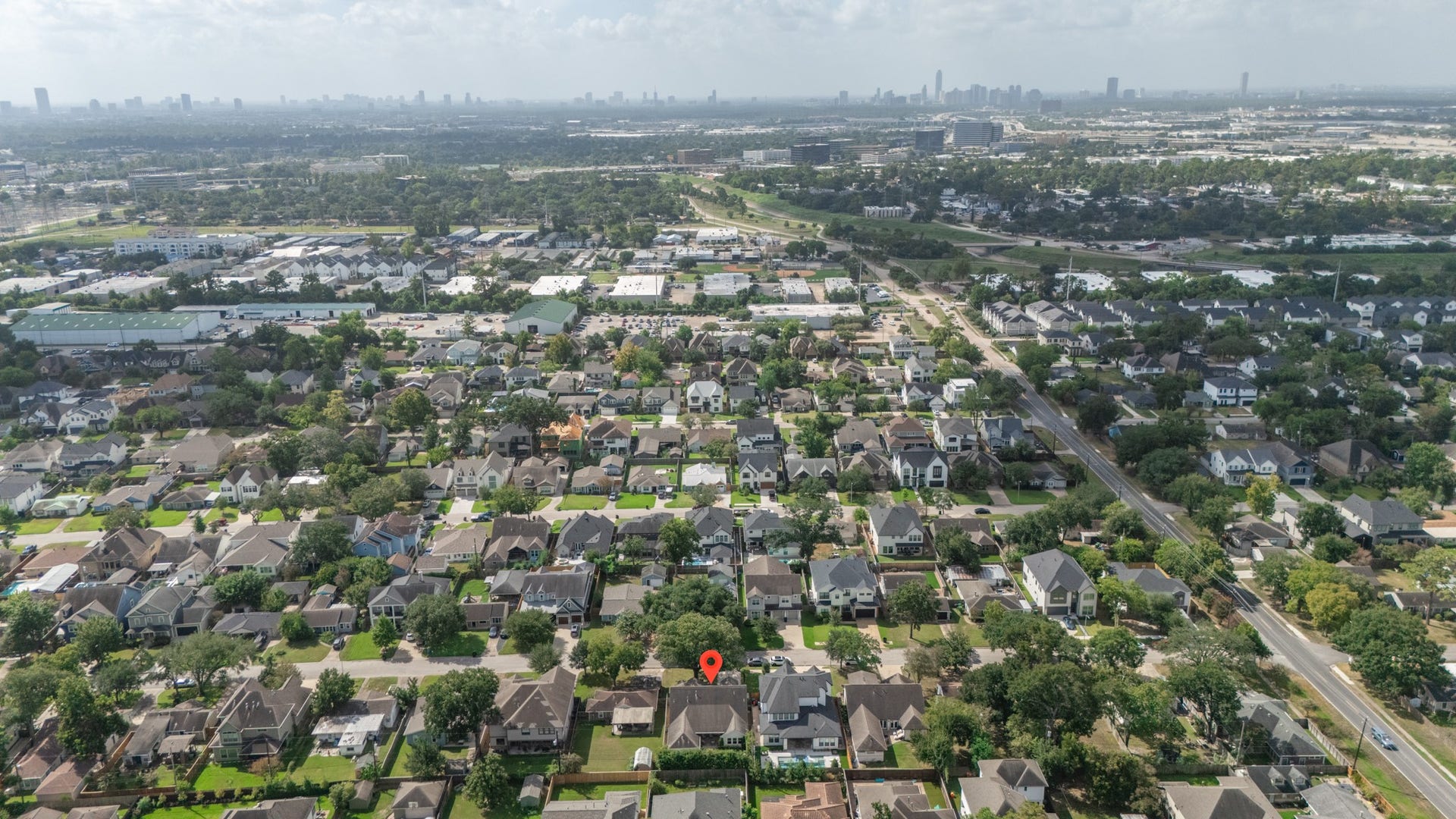 Charming suburban neighborhood with tree-lined streets, surrounded by a vibrant urban landscape offering convenient access to city amenities.