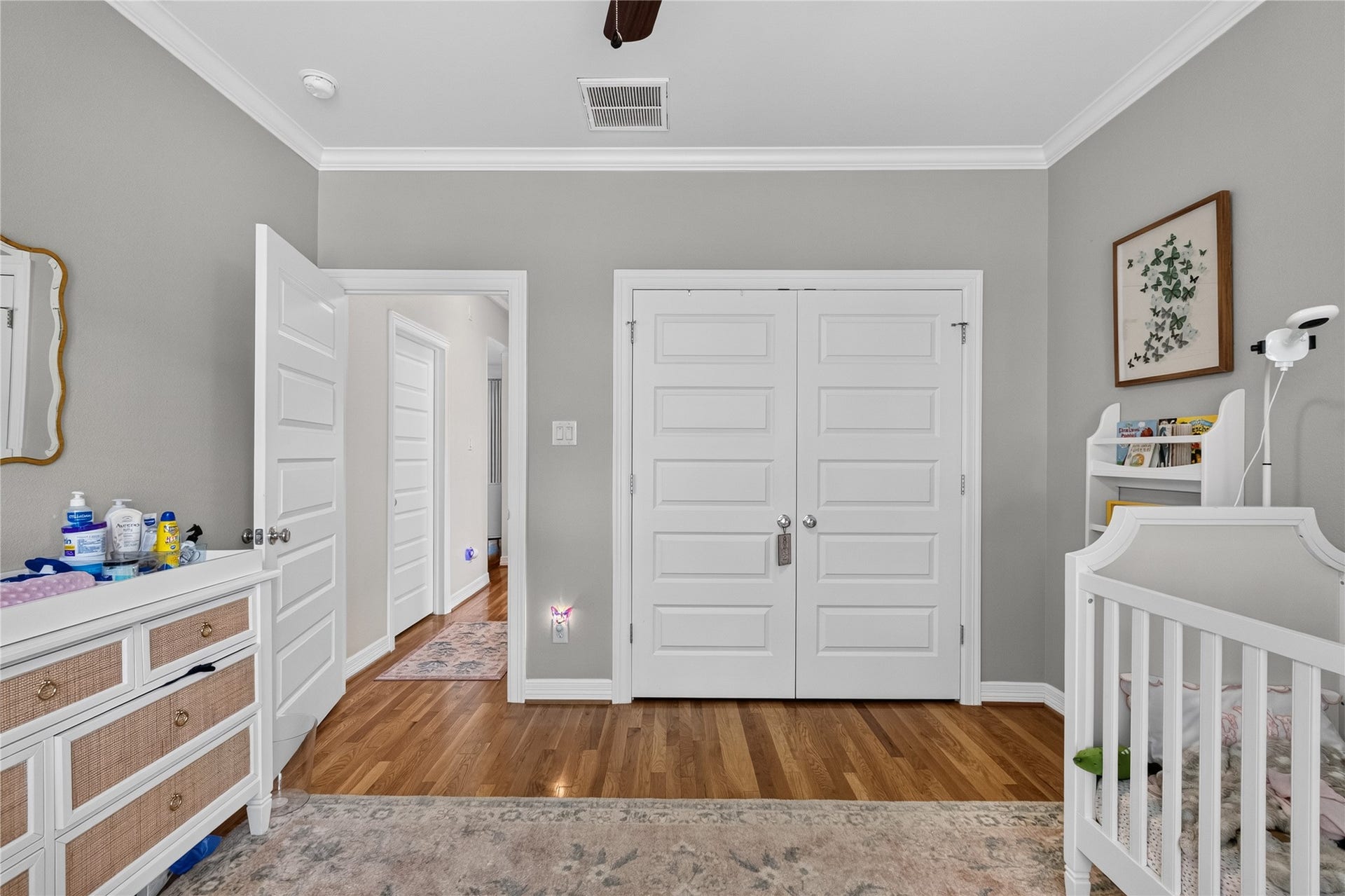 Secondary bedroom featuring elegant white paneled doors and soft neutral walls.