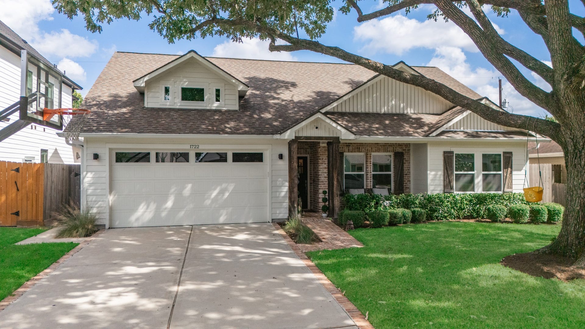 Welcome to 1722 Chippendale! Charming single-story home with a spacious two-car garage, a double-wide driveway, nestled under mature trees, and featuring a welcoming brick pathway and lush landscaping.