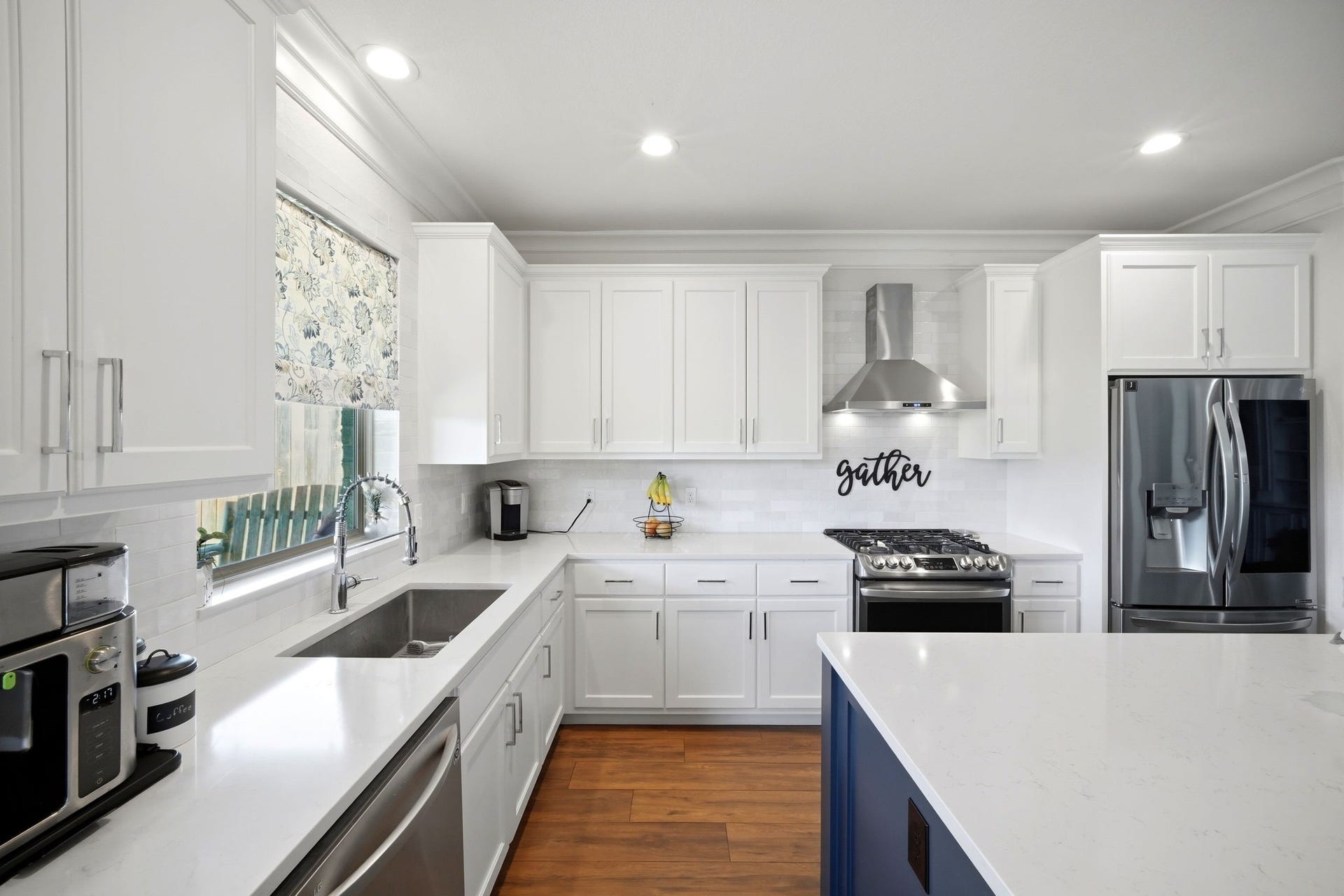 21639 Lexor Drive, Porter, TX 77365 Bright and modern kitchen featuring sleek white cabinetry, stainless steel appliances, and a spacious island with elegant countertops.