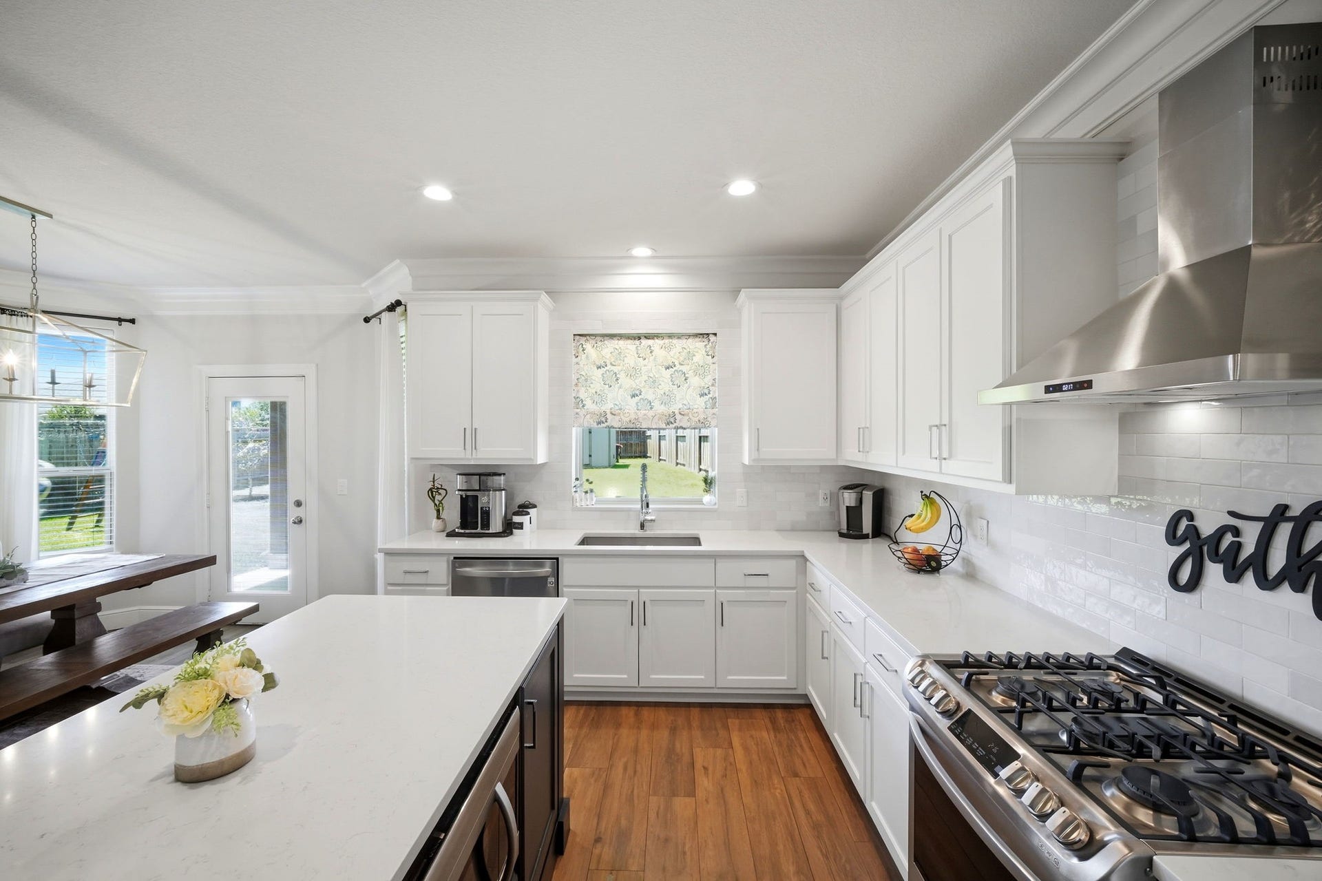 21639 Lexor Drive, Porter, TX 77365 Bright and spacious kitchen with sleek white cabinetry, a large island, and modern stainless steel appliances.