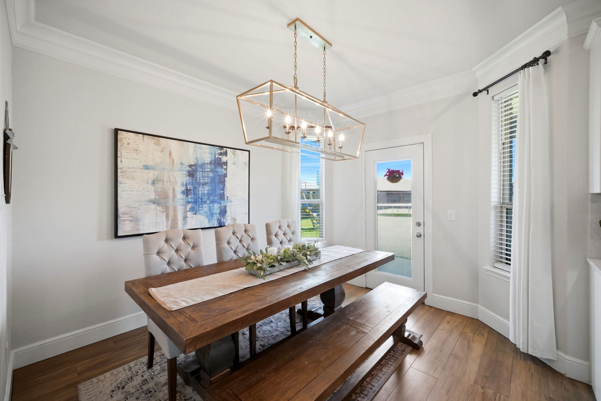 21639 Lexor Drive, Porter, TX 77365 Elegant dining area accented by a modern chandelier and abundant natural light from large windows and a glass door.