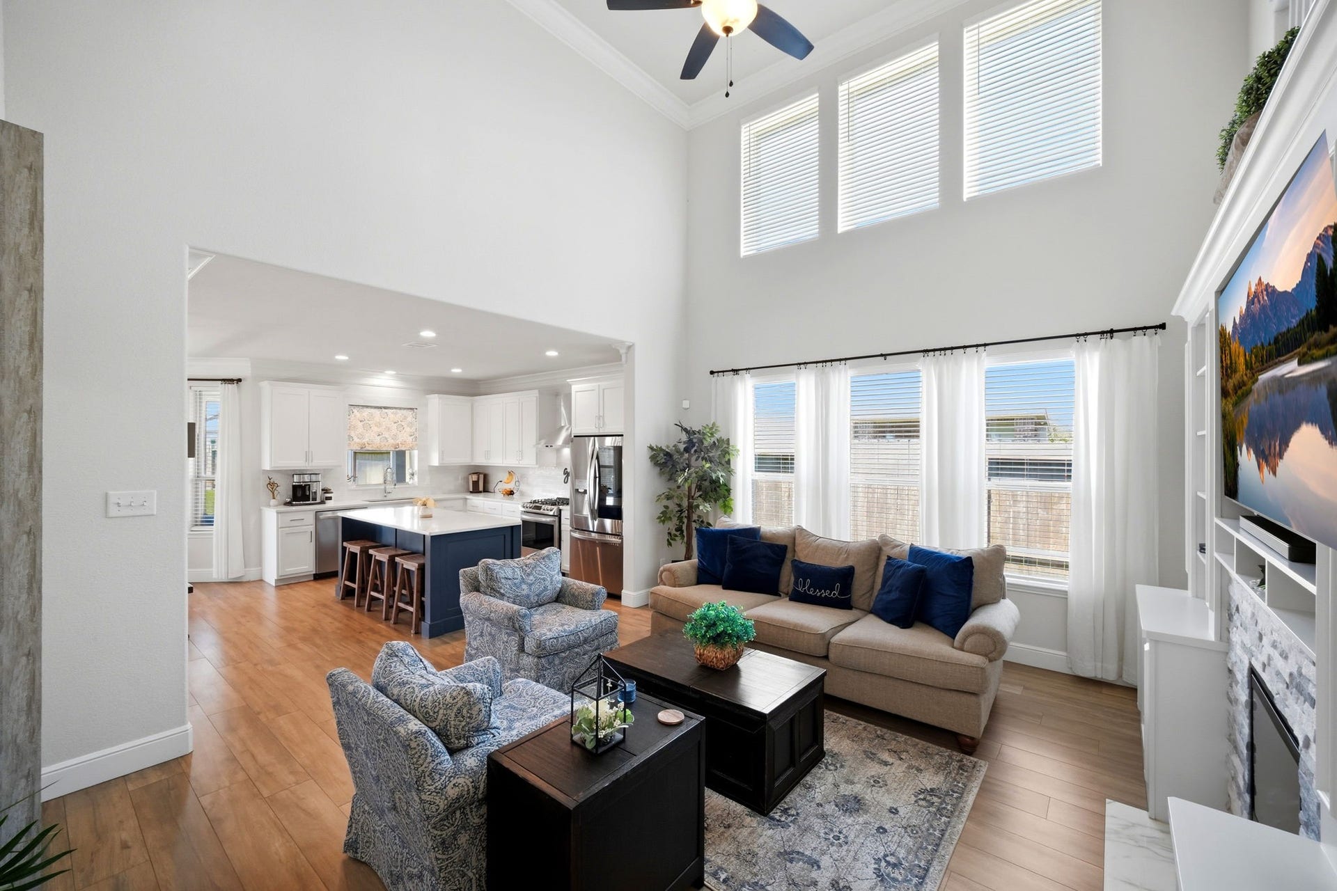 21639 Lexor Drive, Porter, TX 77365 Spacious living area with high ceilings, abundant natural light from large windows, and an open layout leading to a modern kitchen.