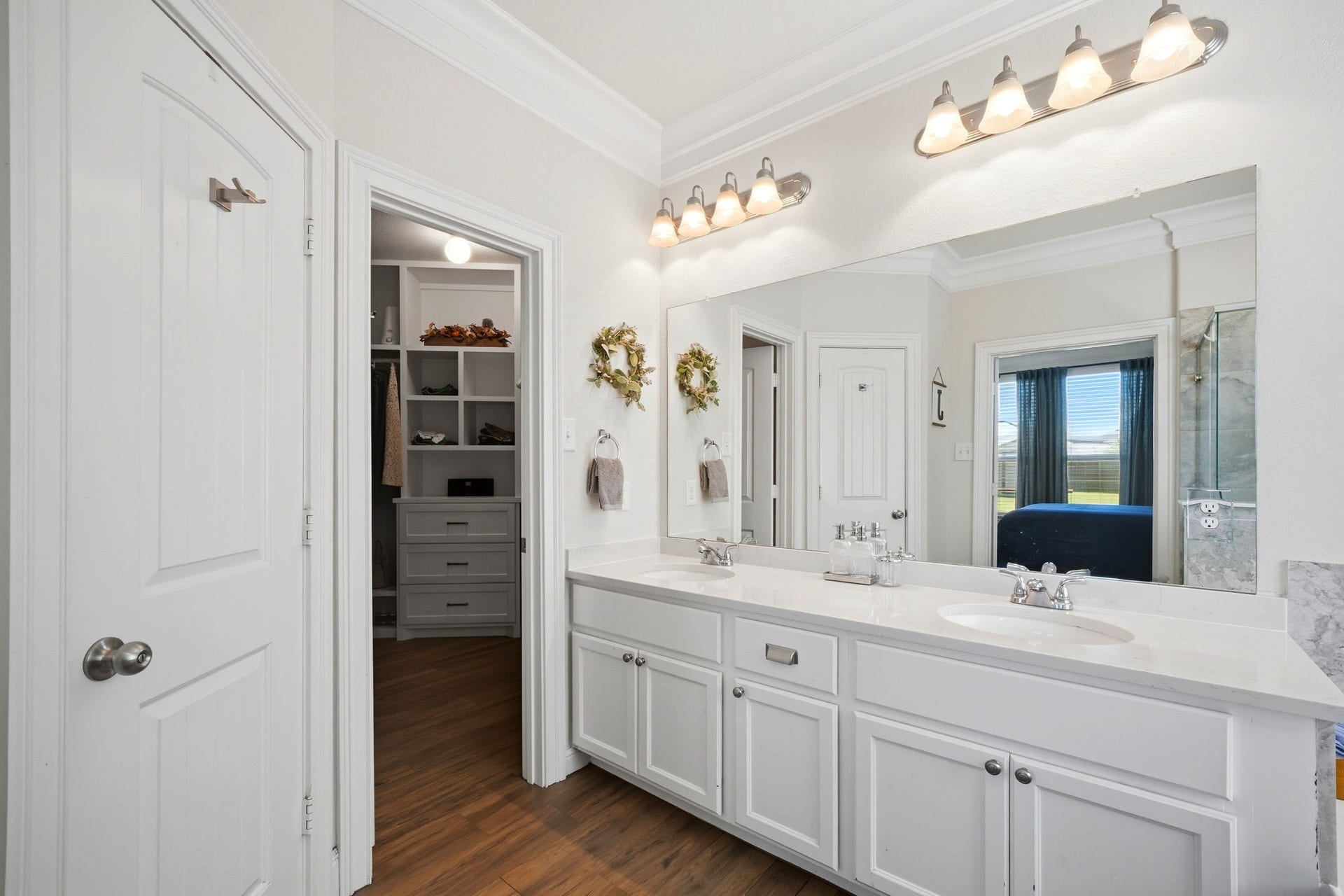 21639 Lexor Drive, Porter, TX 77365 Elegant bathroom featuring dual sinks, ample counter space, and modern lighting, seamlessly connected to a spacious walk-in closet.