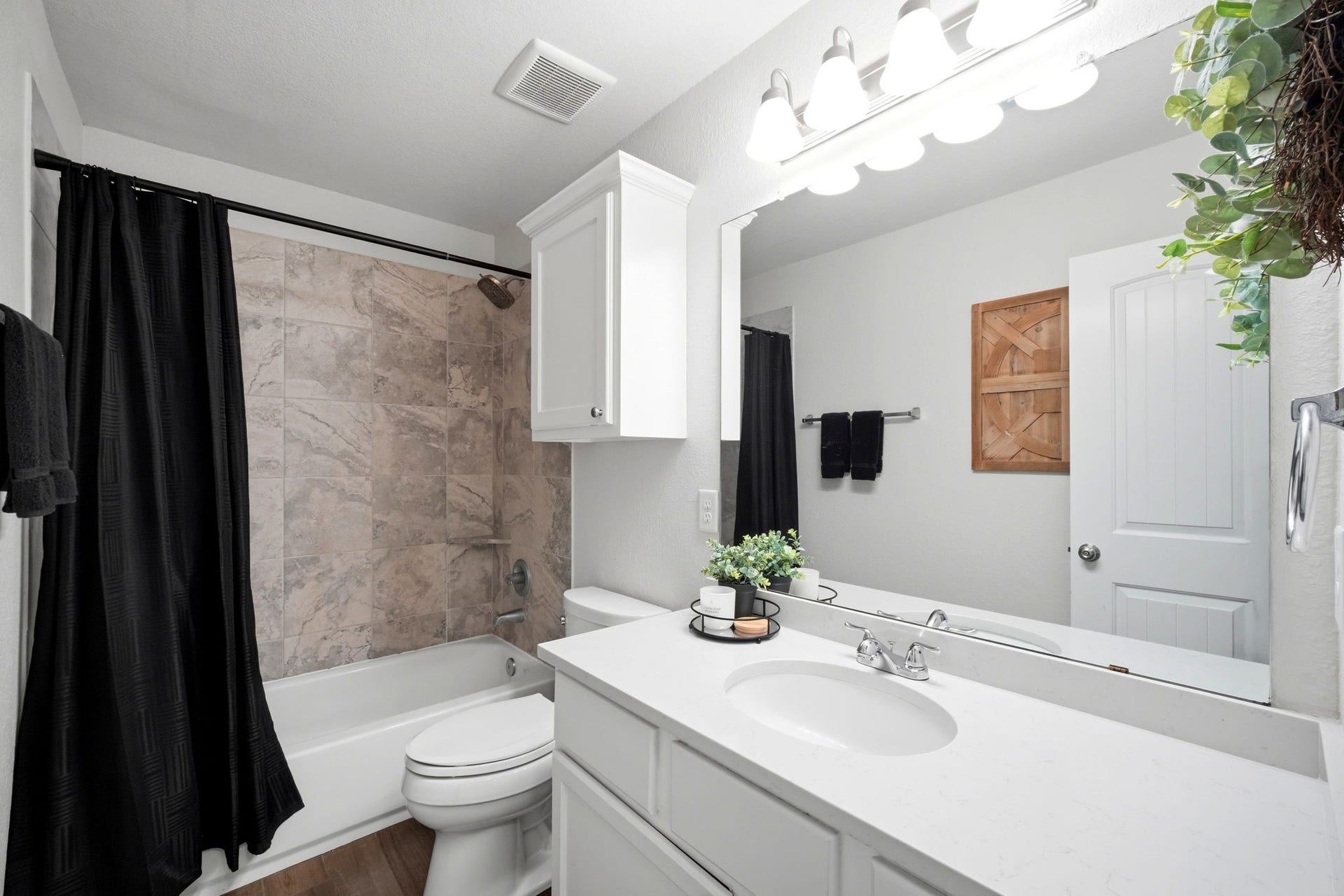21639 Lexor Drive, Porter, TX 77365 Chic bathroom with a sleek white vanity, elegant tile surround, and modern fixtures.