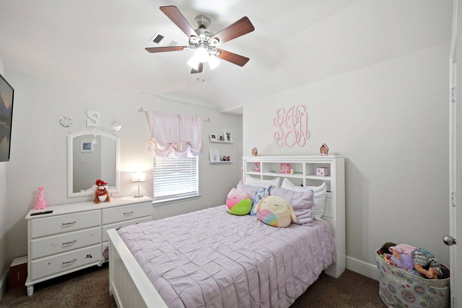 21639 Lexor Drive, Porter, TX 77365 Charming and cozy bedroom features a stylish ceiling fan, plush carpet, and ample natural light, creating a welcoming and serene atmosphere.