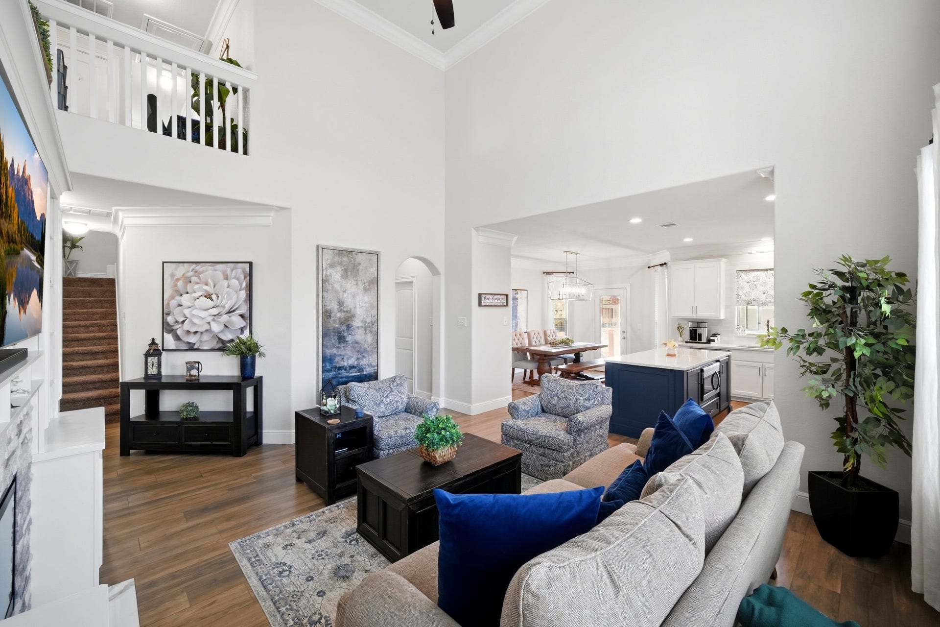 21639 Lexor Drive, Porter, TX 77365 Spacious living area with high ceilings, seamlessly flowing into a bright, modern kitchen and dining space.