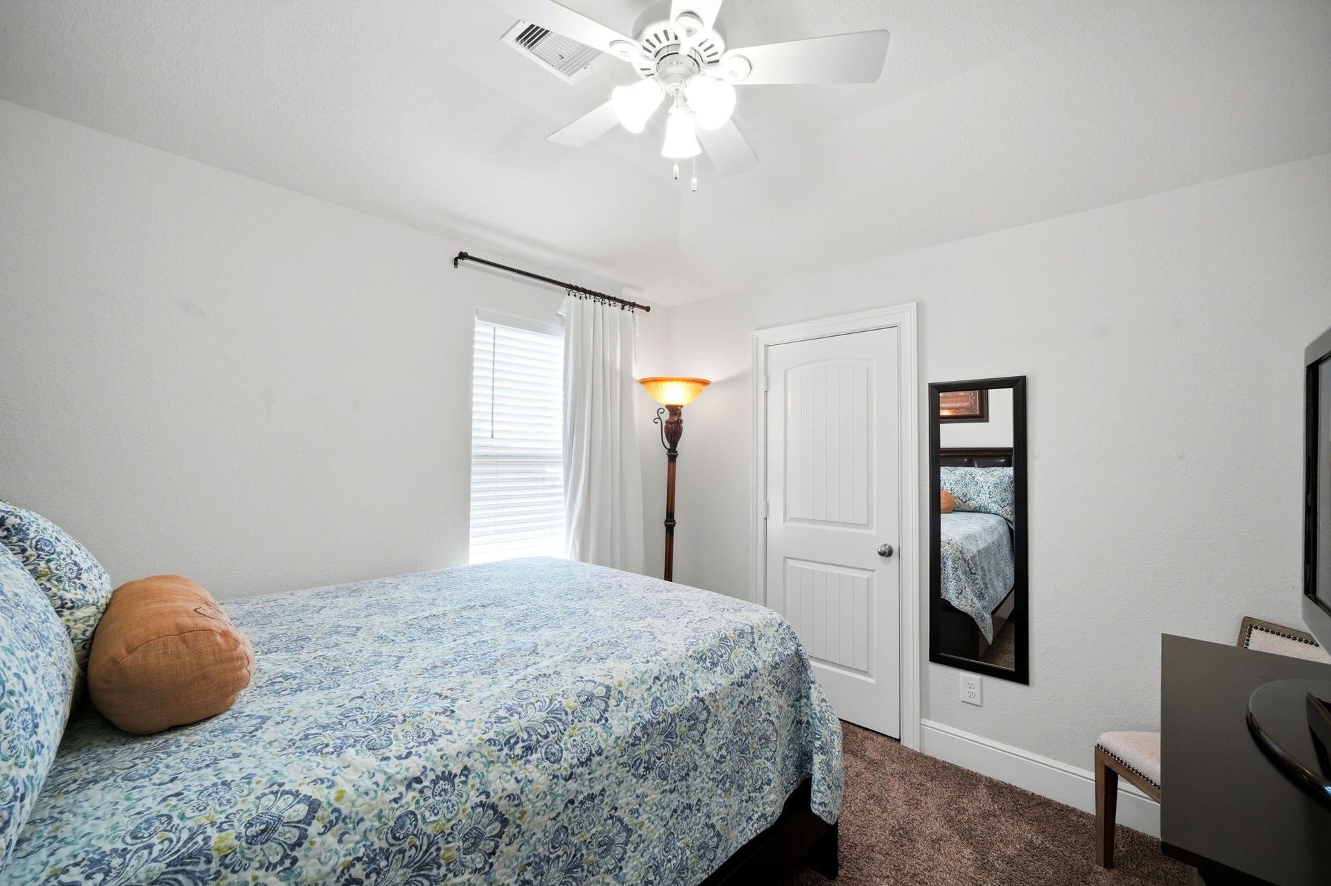 21639 Lexor Drive, Porter, TX 77365 Cozy bedroom featuring soft carpet, a ceiling fan, and ample natural light from the window, creating a welcoming atmosphere.