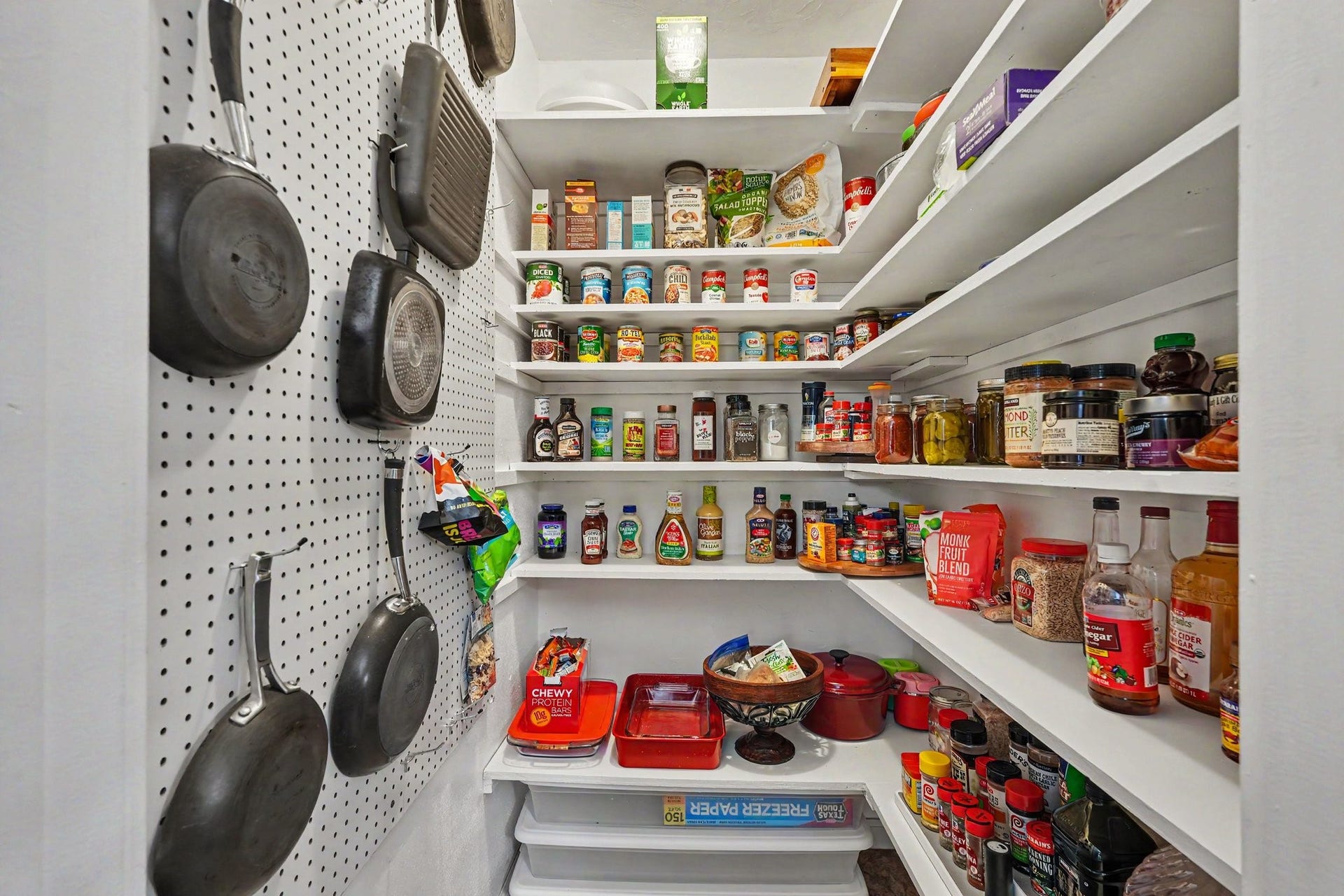 24609 Willow Lane, Hockley, TX 77447 Large walk-in pantry with extensive built-in shelving and additional wall storage for cookware and kitchen essentials.