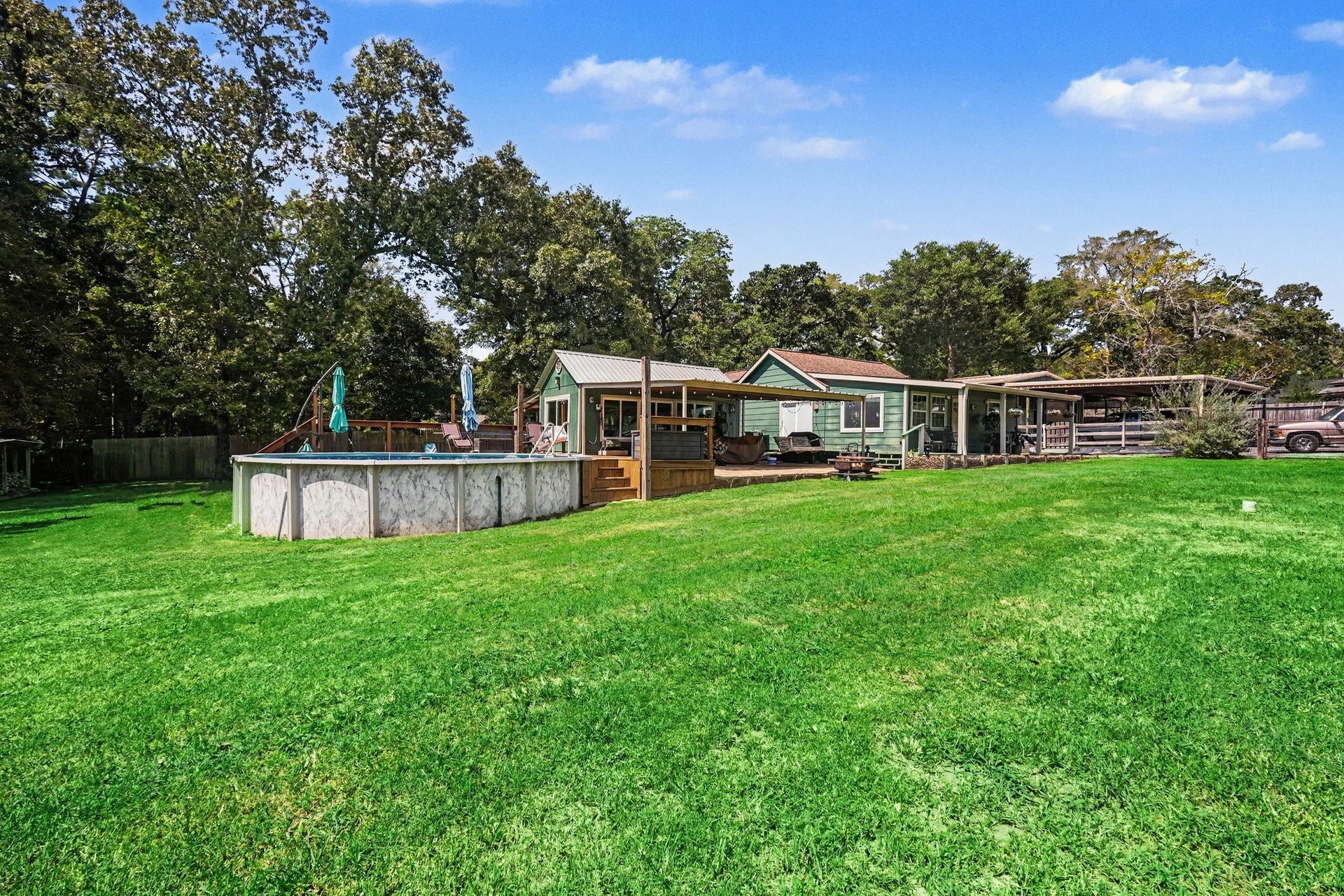 24609 Willow Lane, Hockley, TX 77447 Another view showcasing the large lawn, pool area, and multiple covered outdoor living spaces.