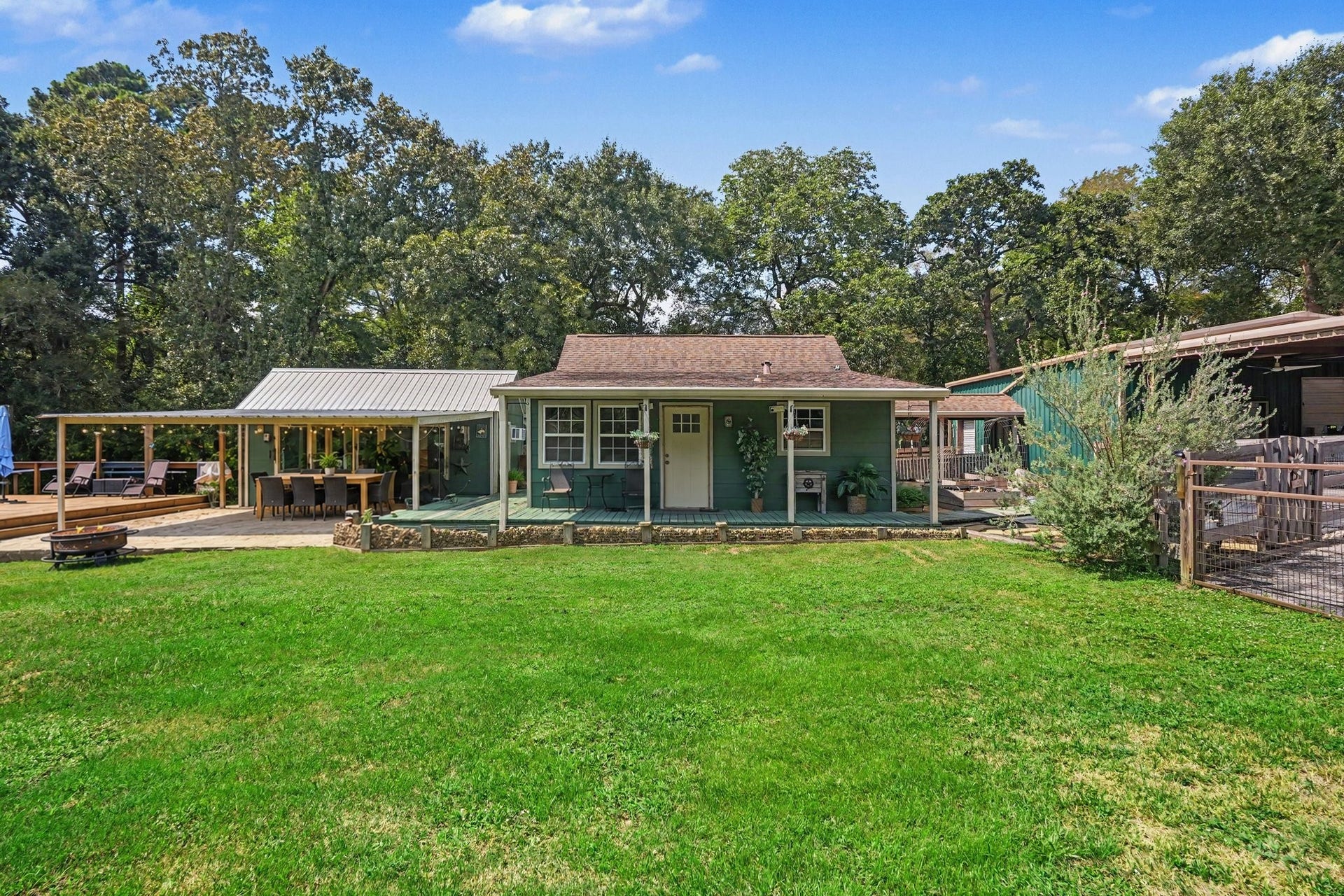 24609 Willow Lane, Hockley, TX 77447 Spacious lawn with plenty of room to enjoy the outdoors, complemented by mature trees and multiple covered gathering areas. Virtually staged patio furniture.