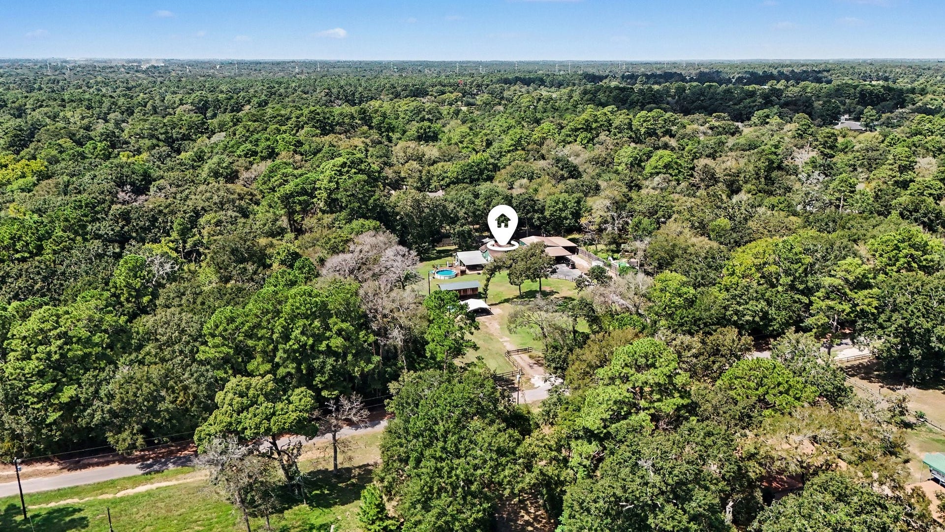 24609 Willow Lane, Hockley, TX 77447 Drone view highlighting the propertys private, wooded setting and surrounding greenery.