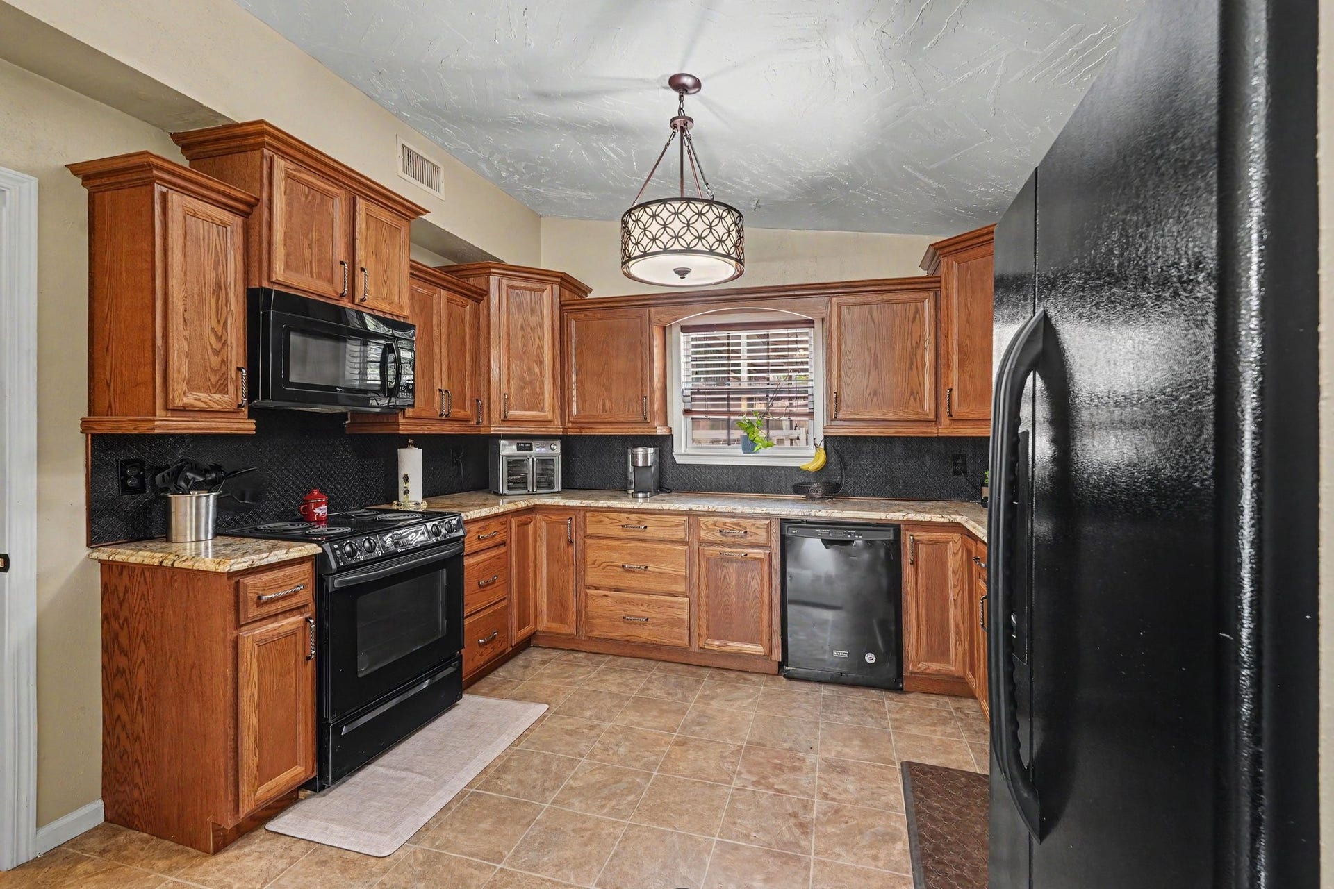 24609 Willow Lane, Hockley, TX 77447 Spacious kitchen featuring abundant wood cabinetry, generous counter space, and a functional layout with plenty of room for meal preparation.