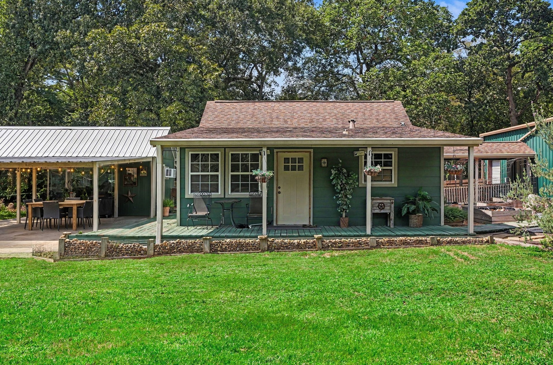 24609 Willow Lane, Hockley, TX 77447 A closer look at the homes welcoming covered porch and peaceful, tree-lined setting. Virtually staged patio furniture.