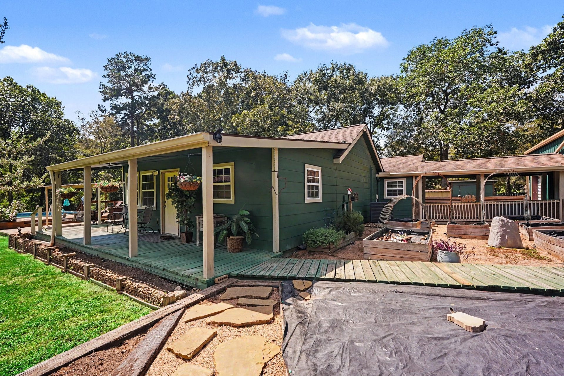 24609 Willow Lane, Hockley, TX 77447 Front exterior view showcasing the homes covered outdoor spaces, garden areas, and surrounding greenery.