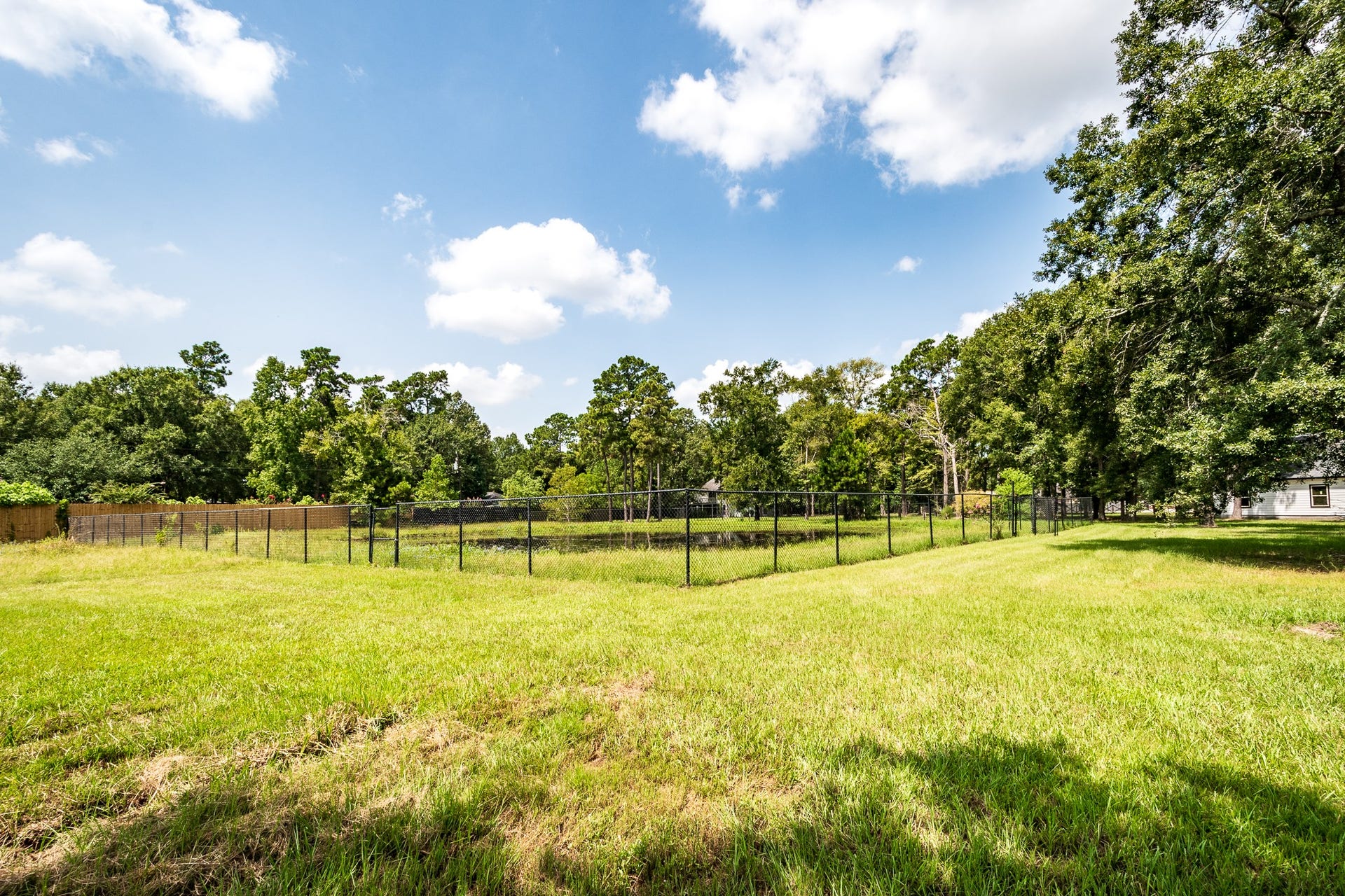 16111 Porter Lane, Porter, TX 77365 Fenced pond located on south side of Porter Lane 8.5+/-Ac Tract w/ 6 buildings.