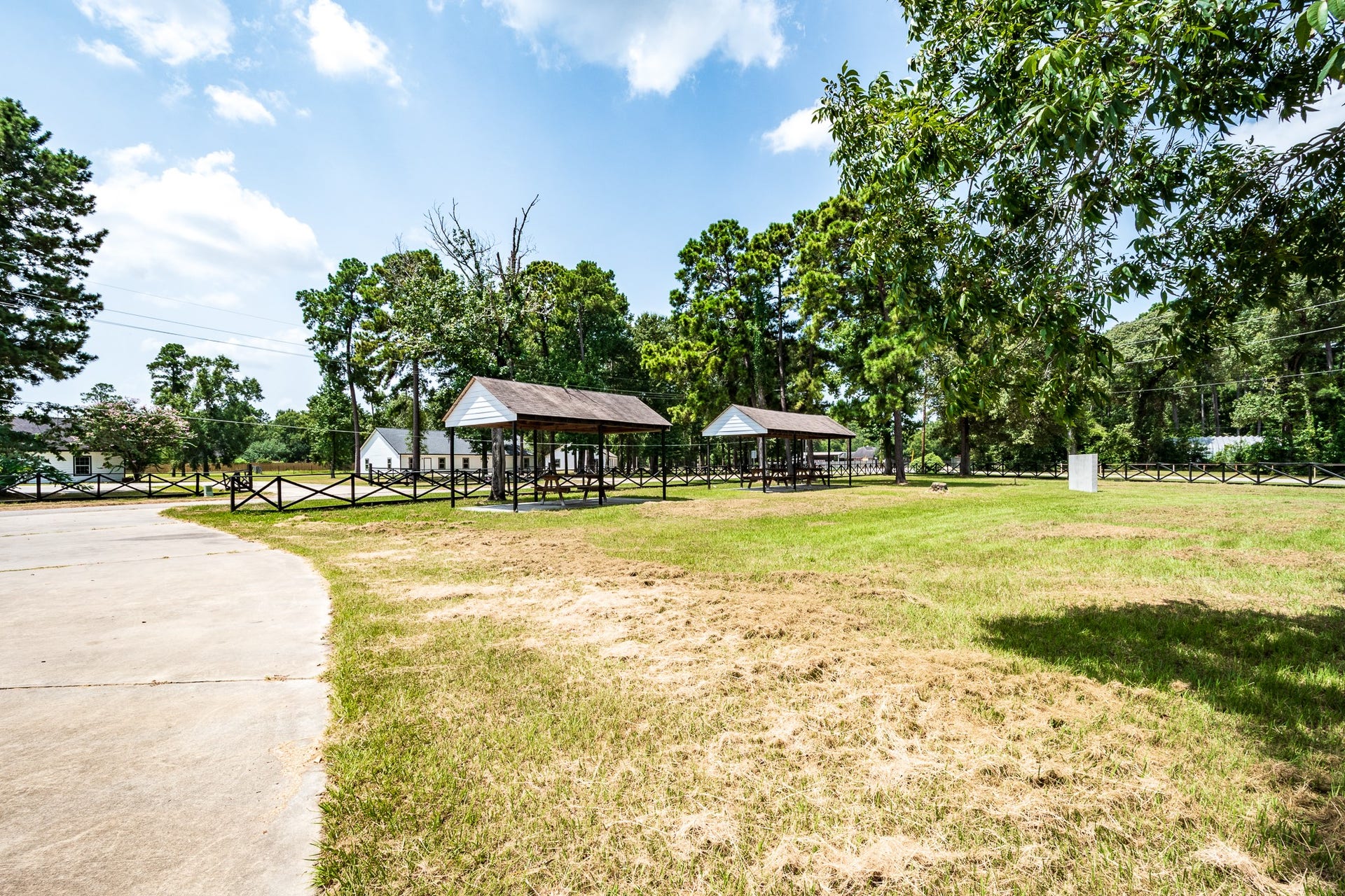 16111 Porter Lane, Porter, TX 77365 Green space with gazebos and mature trees, perfect for outdoor gatherings and relaxation.