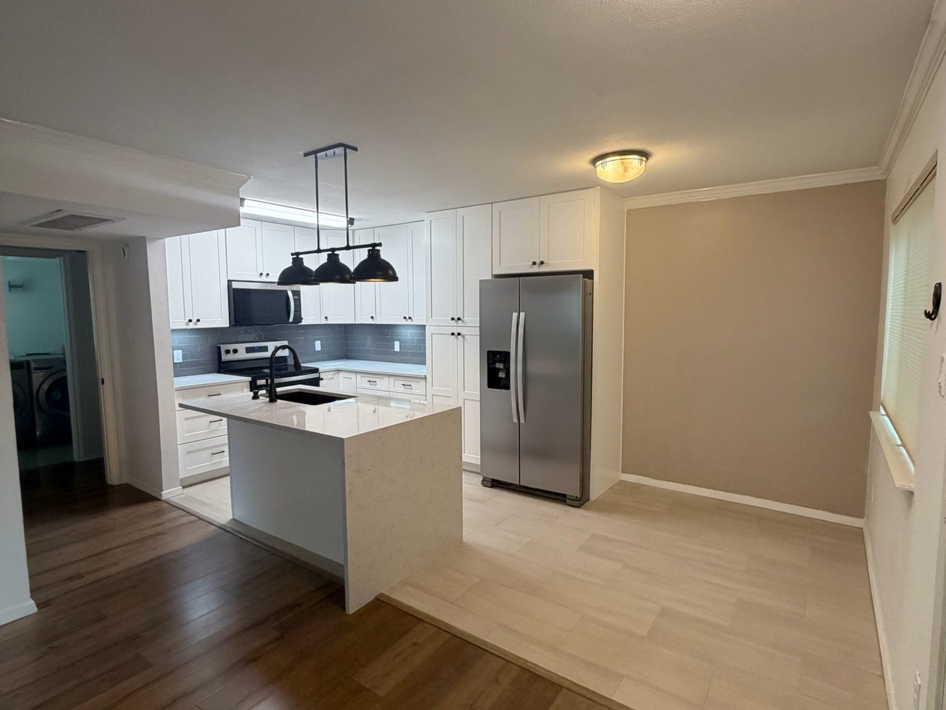 3500 Tangle Brush Drive, #65, The Woodlands, TX 77381 Thoughtfully designed kitchen and dining area maximizes the homes 650 square feet, with extensive cabinetry, stainless steel appliances, a statement island, and a dedicated dining space accented by crown molding and natural light.