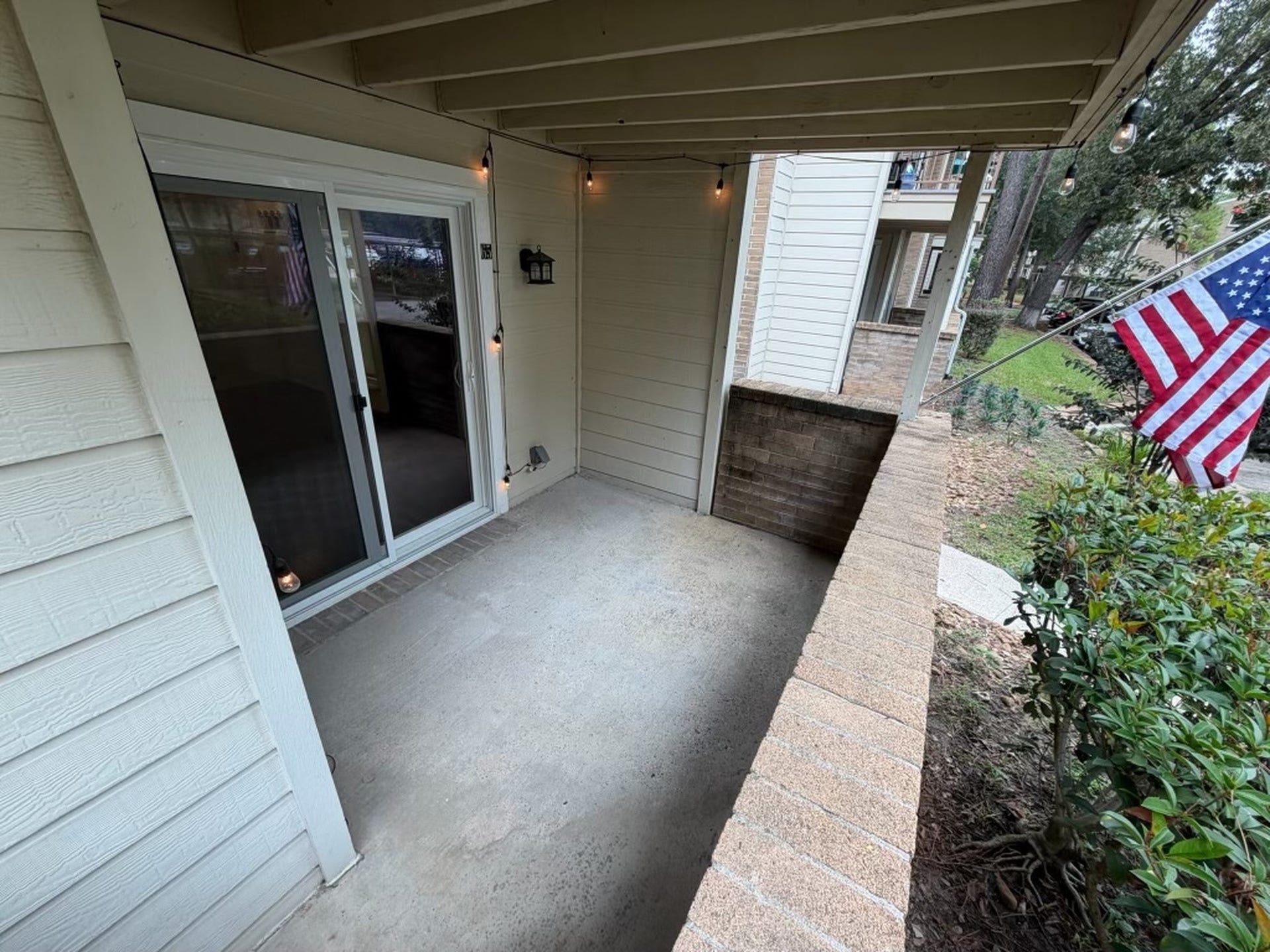 3500 Tangle Brush Drive, #65, The Woodlands, TX 77381 Covered patio offers a comfortable outdoor extension of the living space, with plenty of room for seating and direct access through sliding glass doorsperfect for relaxing or enjoying the surrounding greenery.