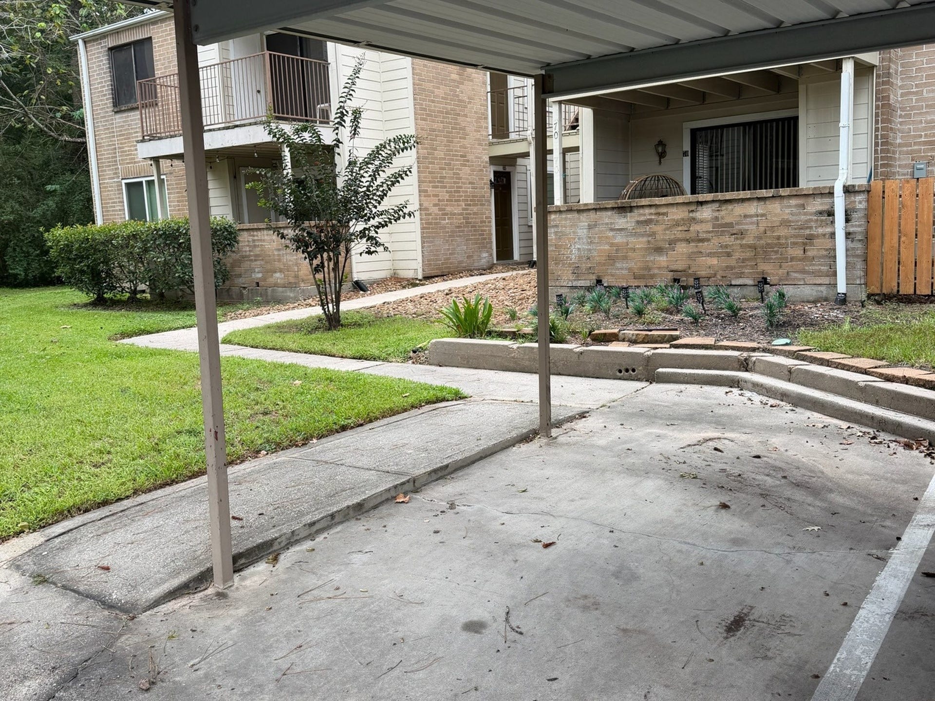 3500 Tangle Brush Drive, #65, The Woodlands, TX 77381 Assigned covered carport space conveniently located just steps from the unit, providing easy everyday access and protection from the elements.
